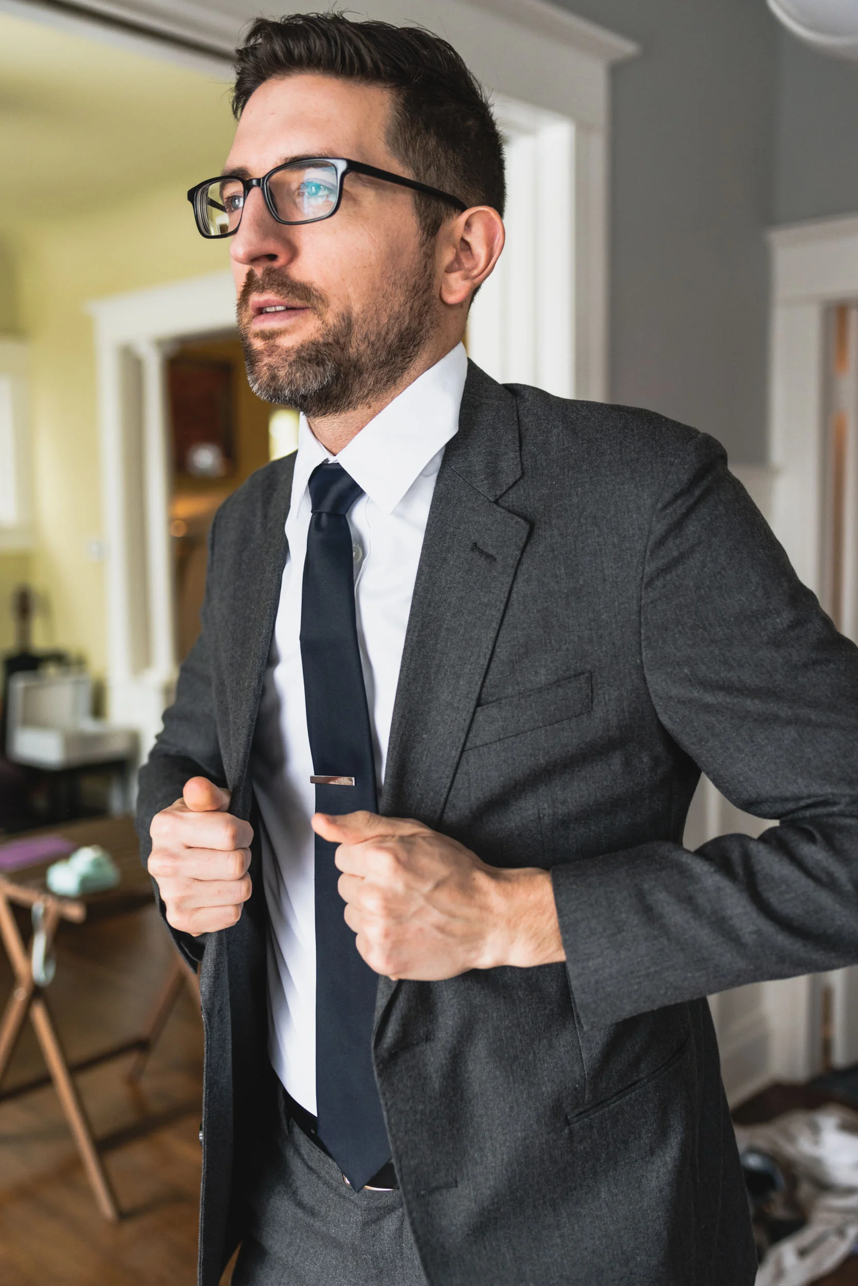 Groom putting on jacket