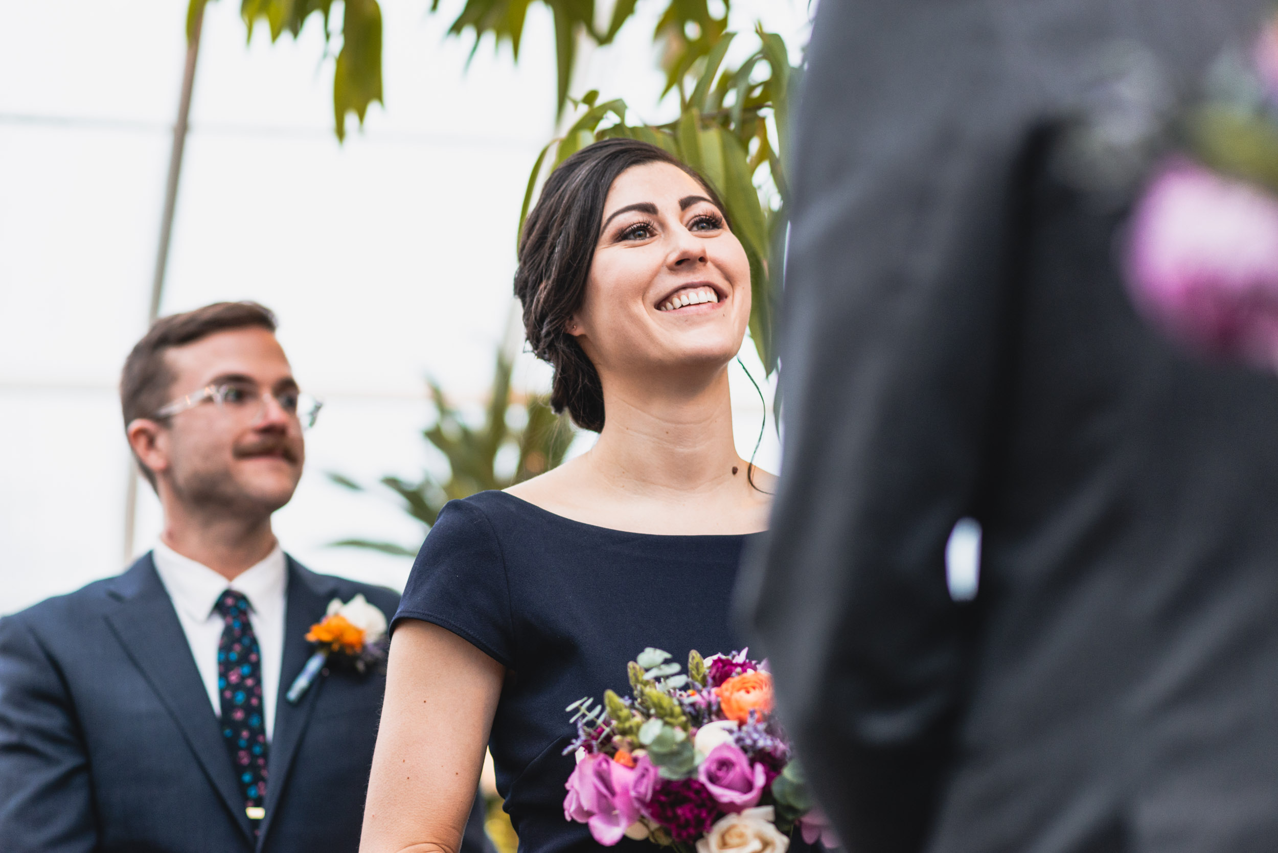 Bride smiles at Groom in conservatory