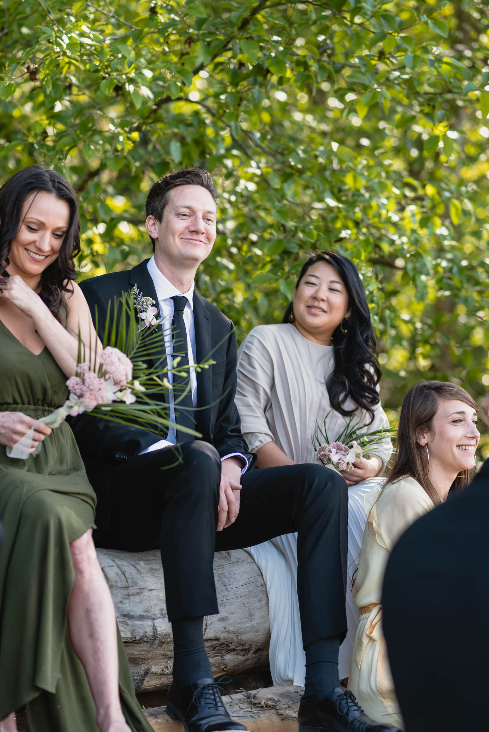 Bridal party at beach with logs