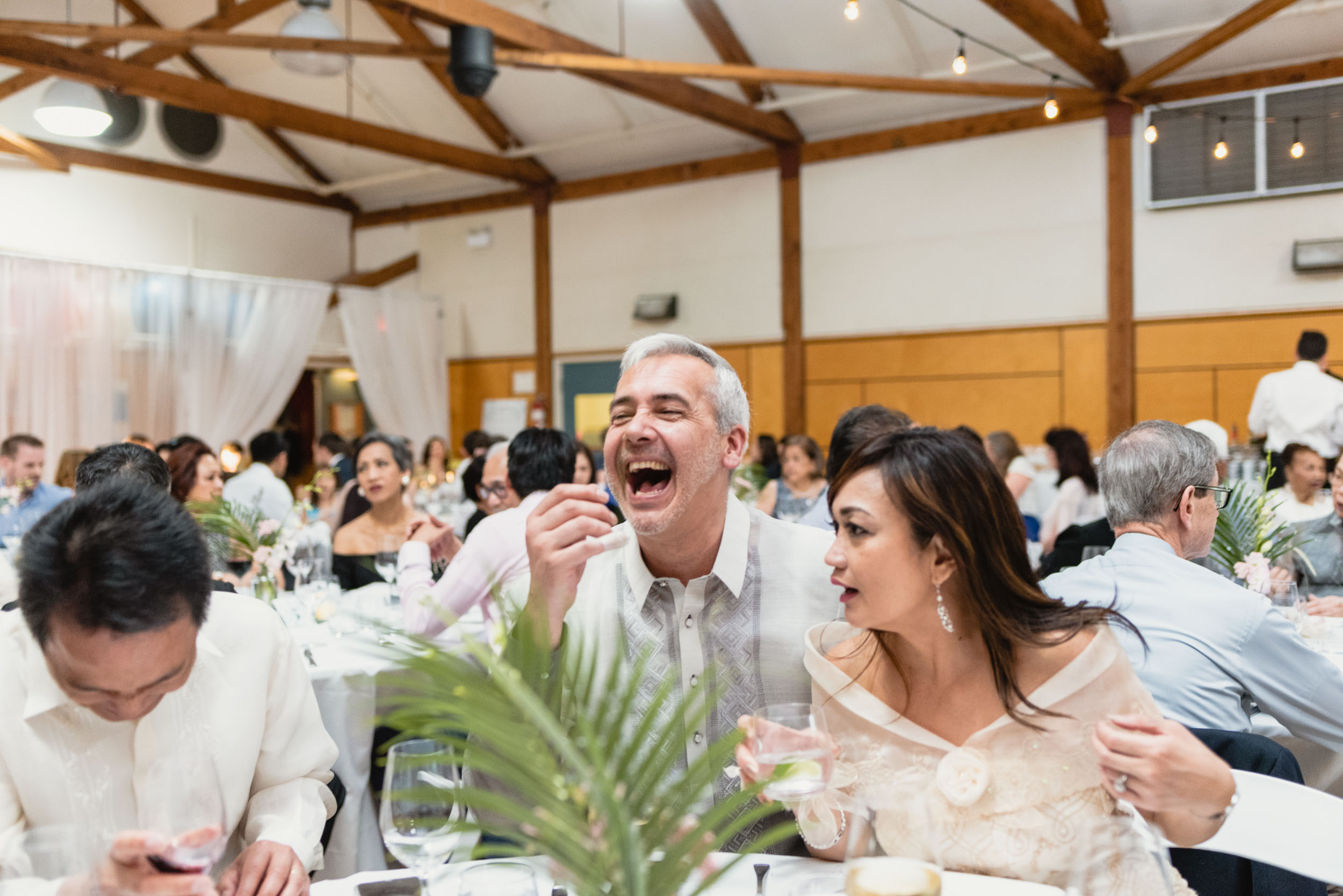 Guests laughing during dinner