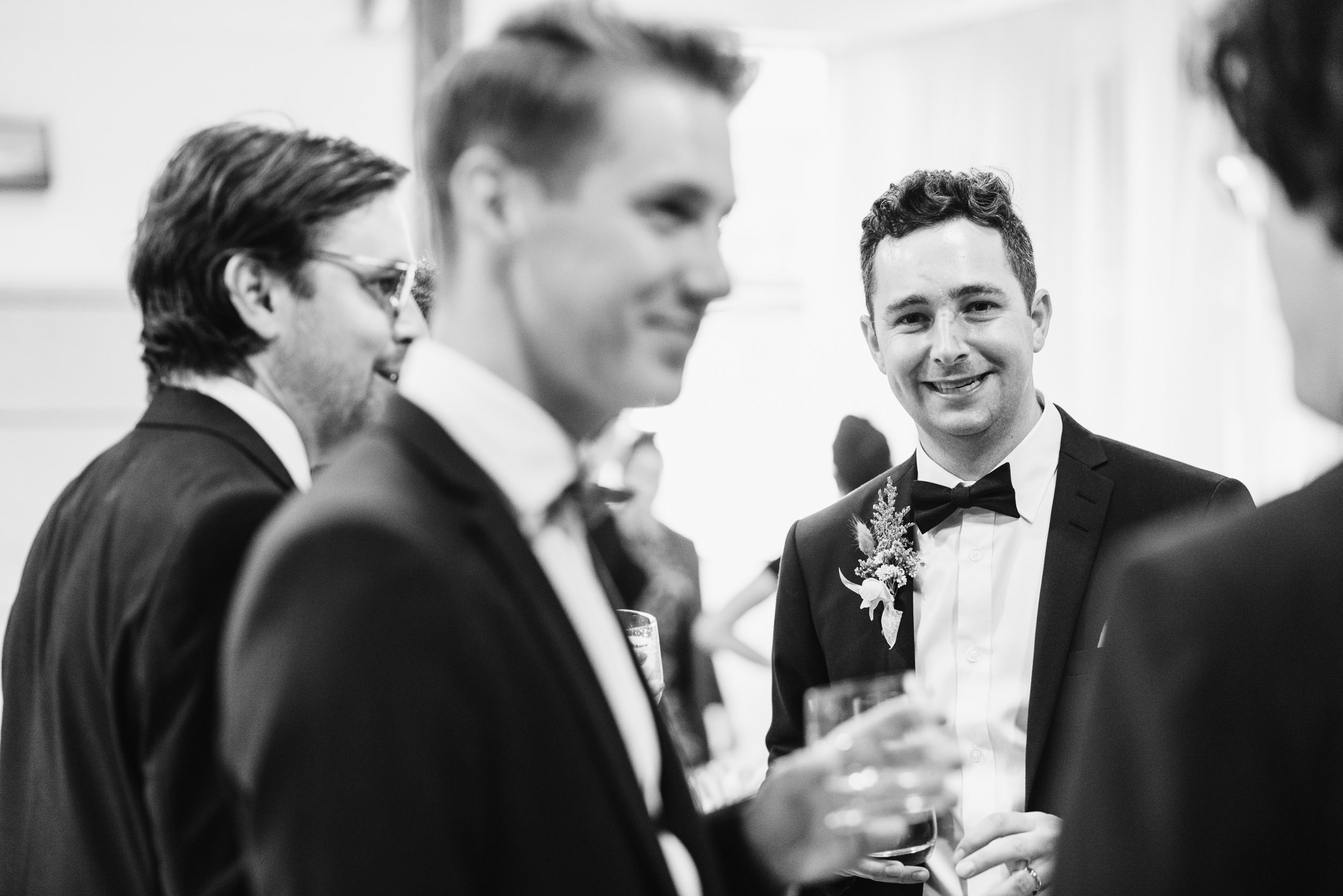 Groom socializing during reception