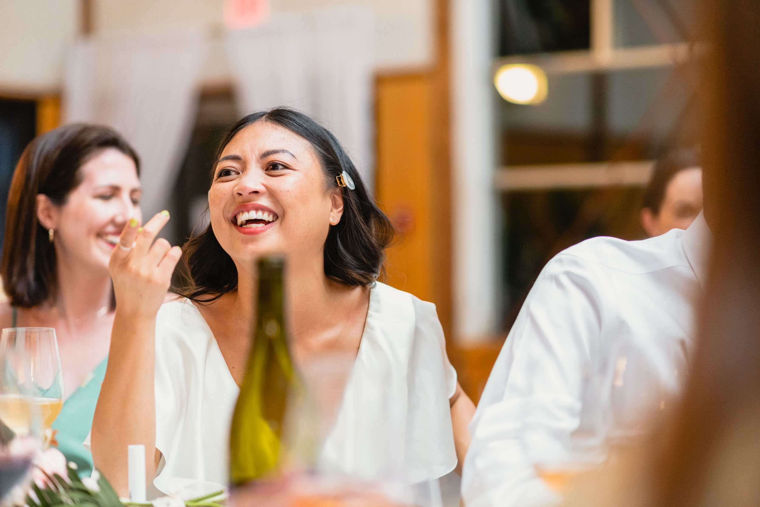 Bride laughs during dinner
