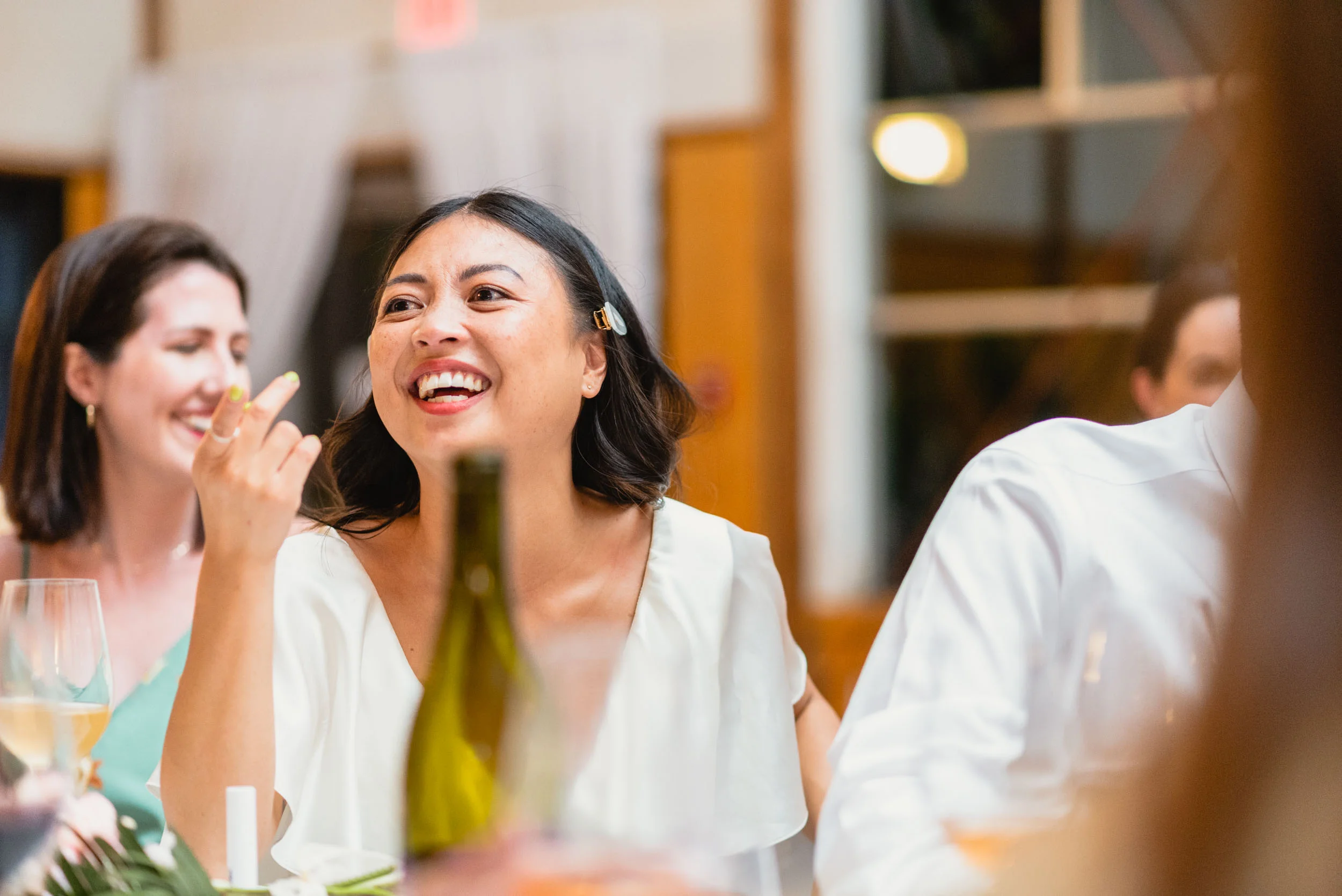 Bride laughs during dinner
