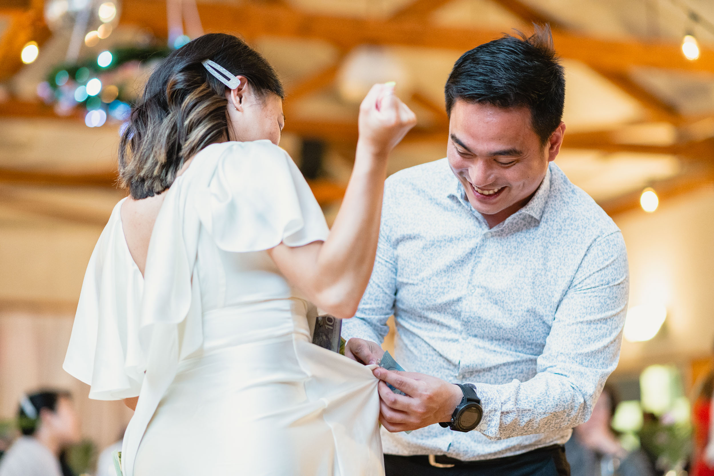 Guest pinning money on Bride