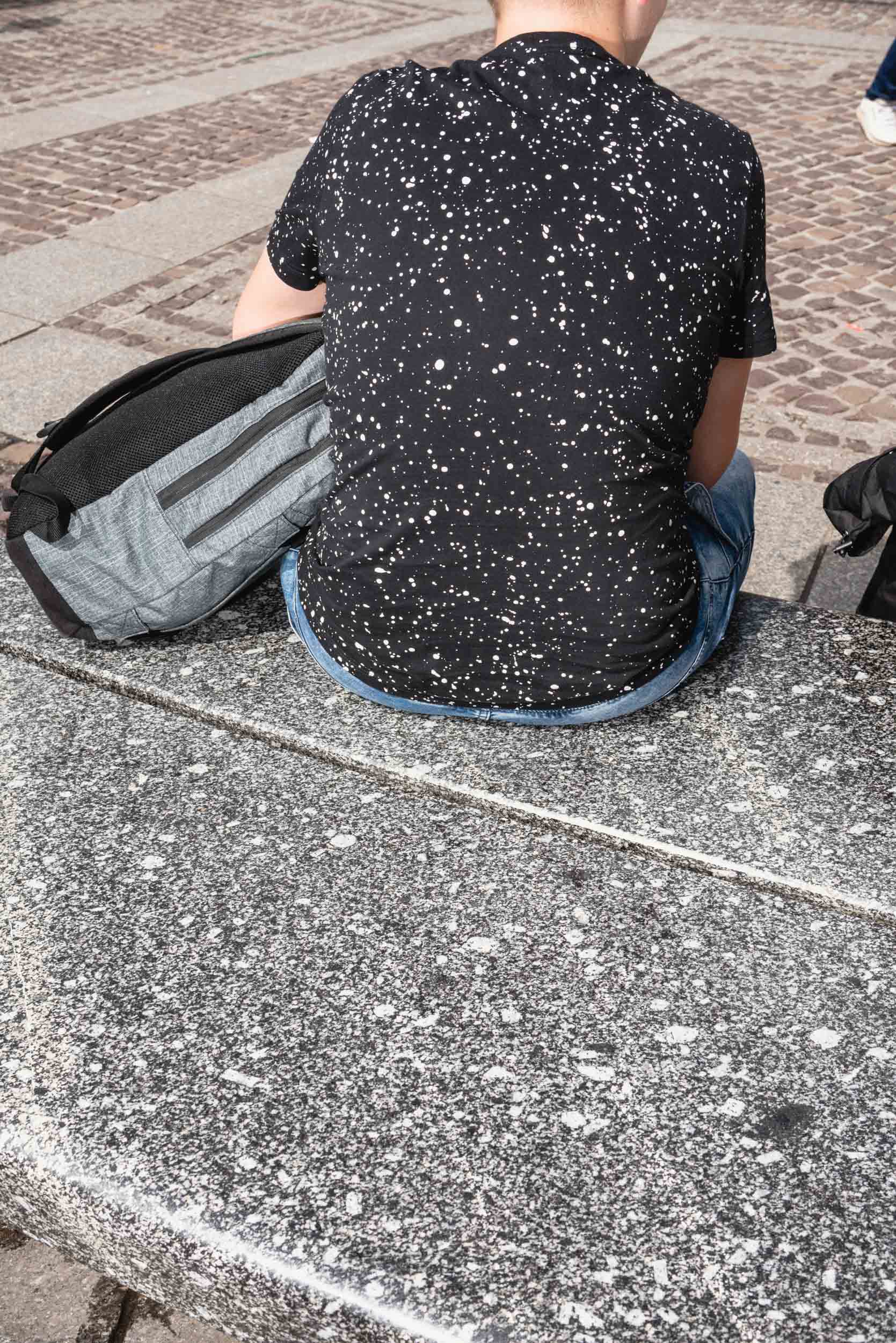 Granite bench and speckled shirt Krakow Old Town Square