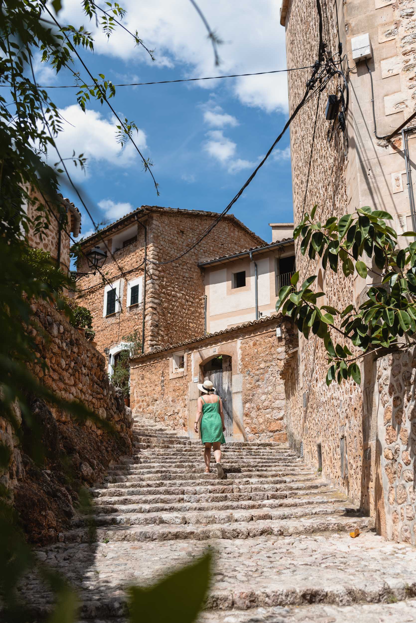 Woman in green dress walking through Fornalutx, Spain