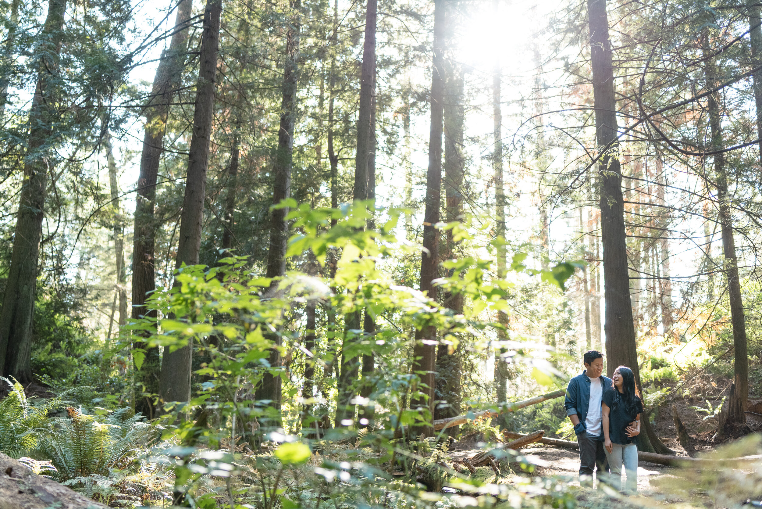 Couple laughing in forest