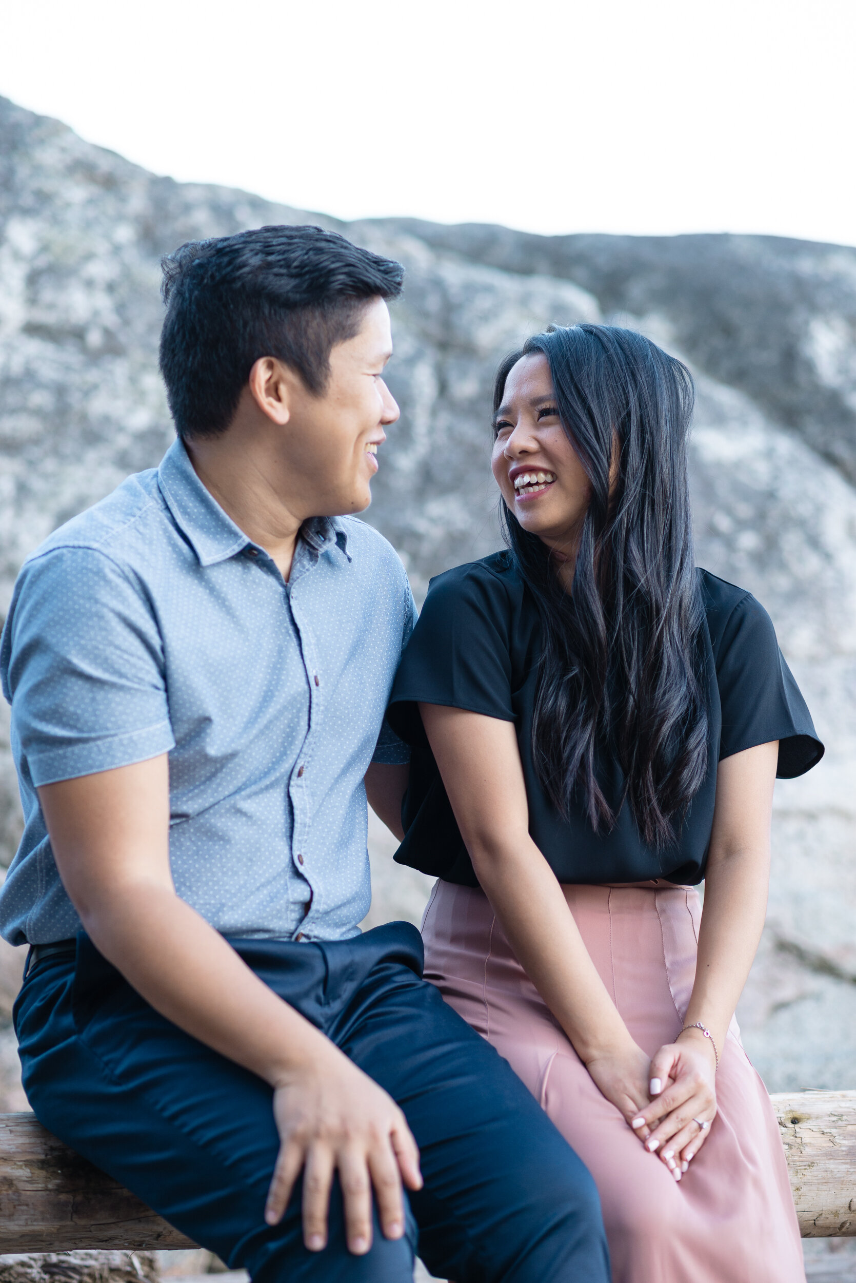 Couple sitting at beach laughing