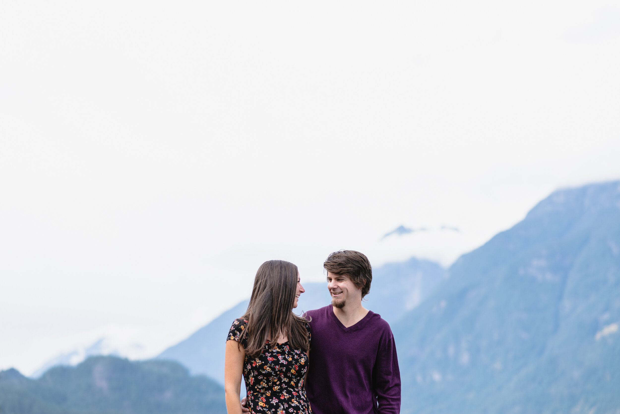 Couple smiling with mountain backdrop