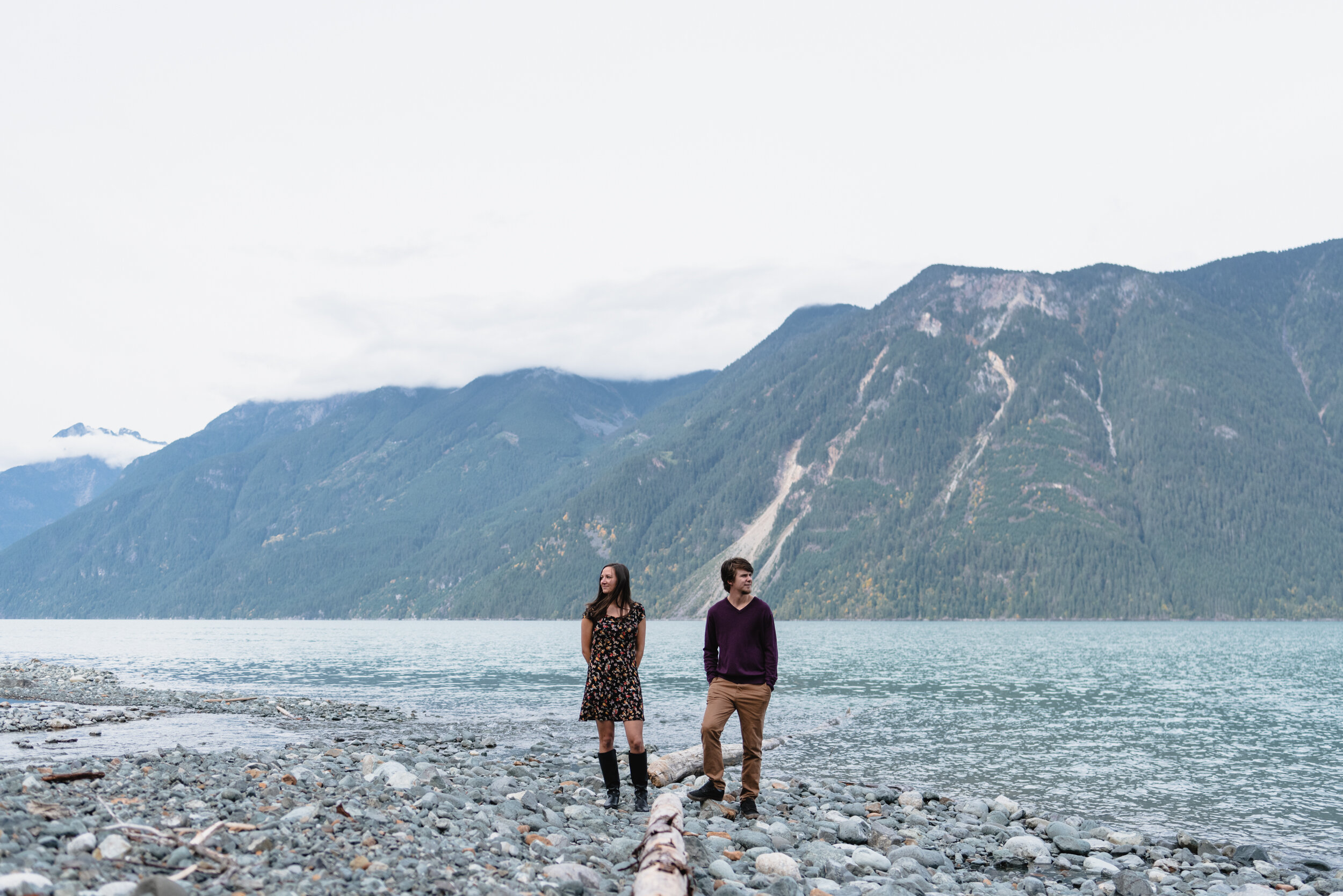 Couple standing with lake and mountain backdrop