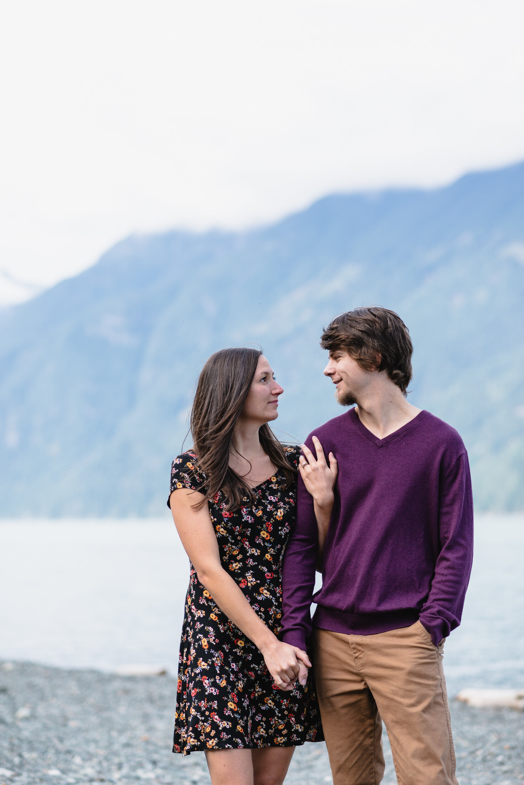 Couple smiling at each other at lakeshore
