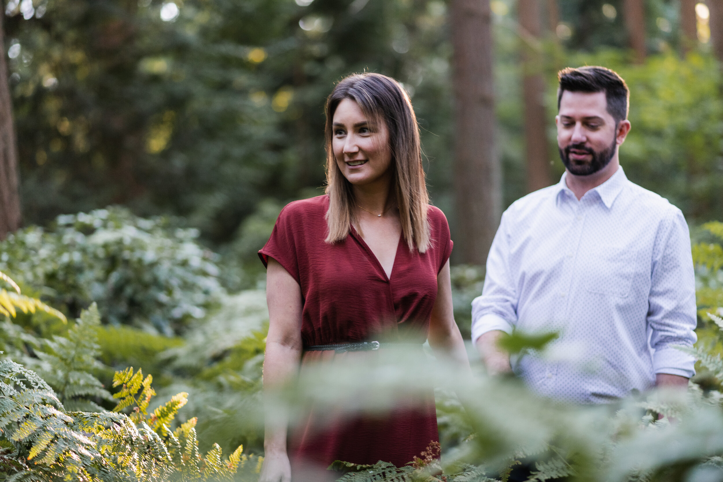 Couple walking through ferns