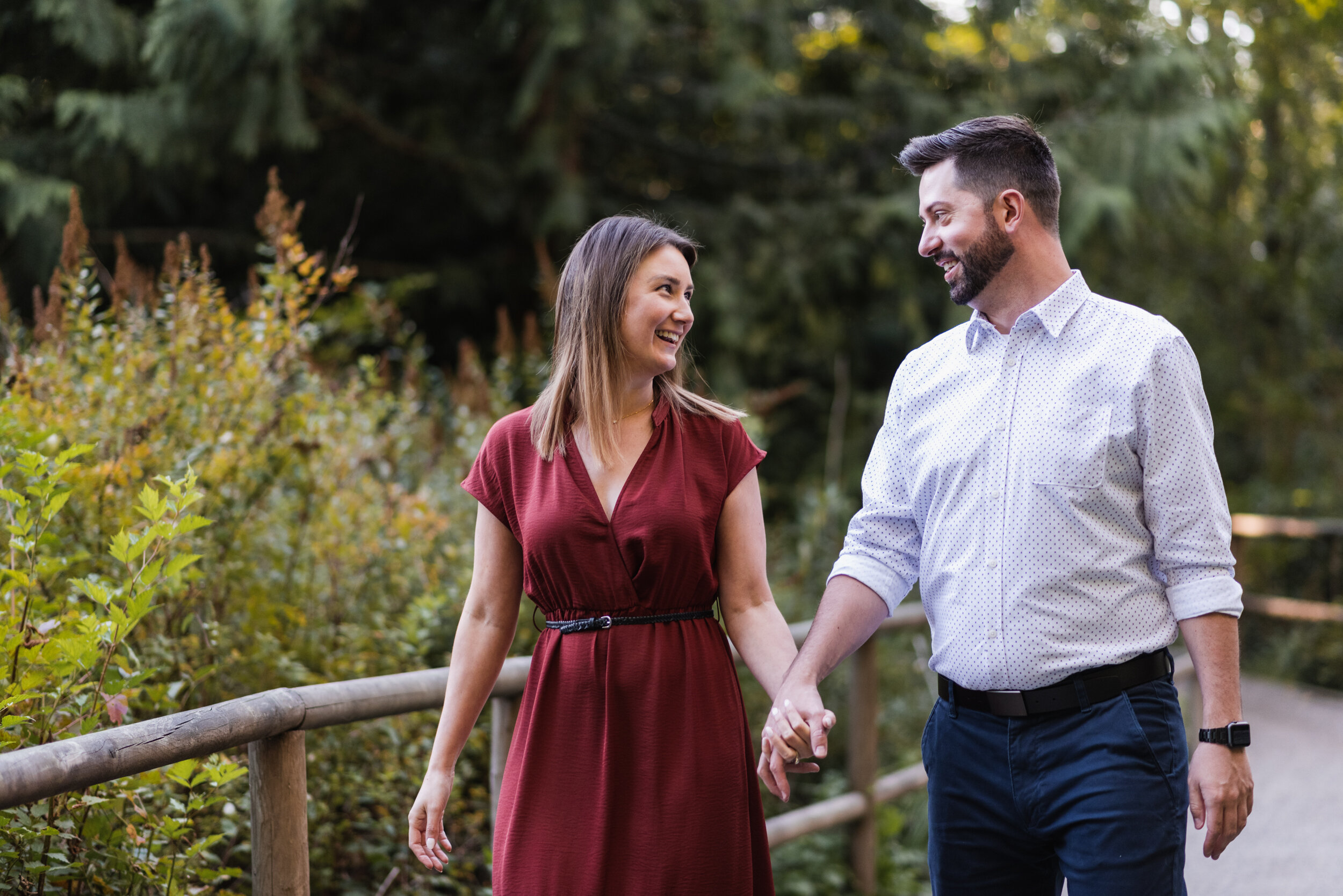 Couple holding hands walking through park