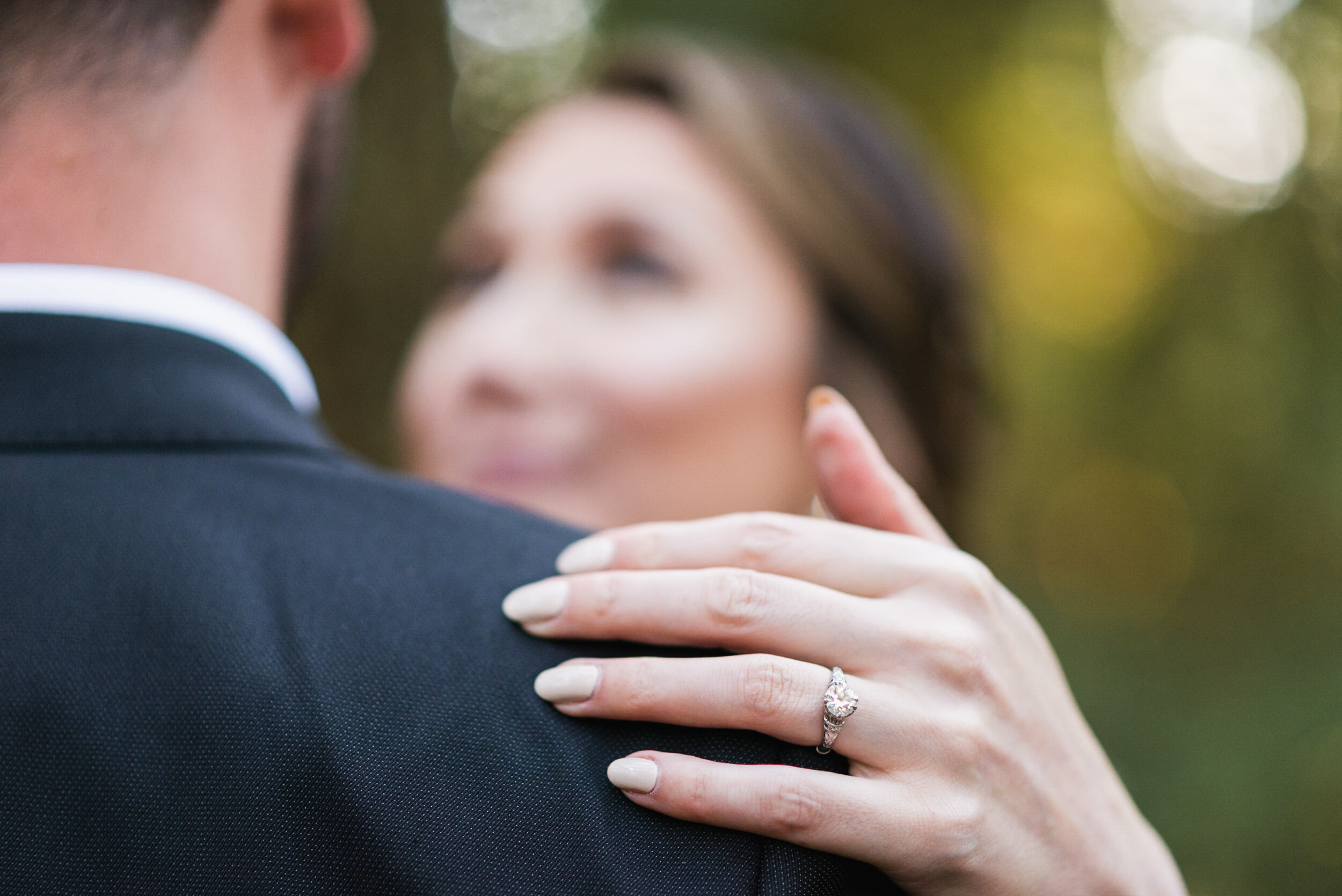 Bride's hand on Groom's shoulder ring