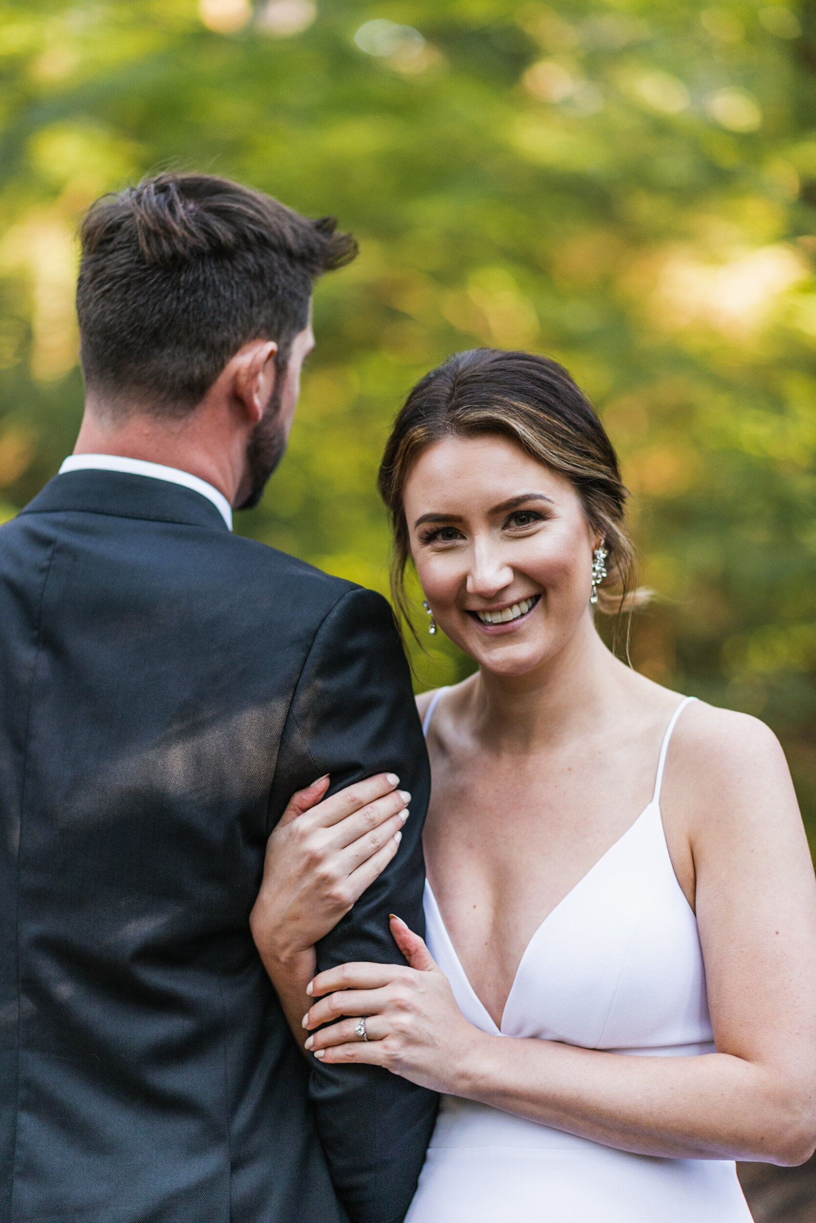 Bride and Groom embrace in forest