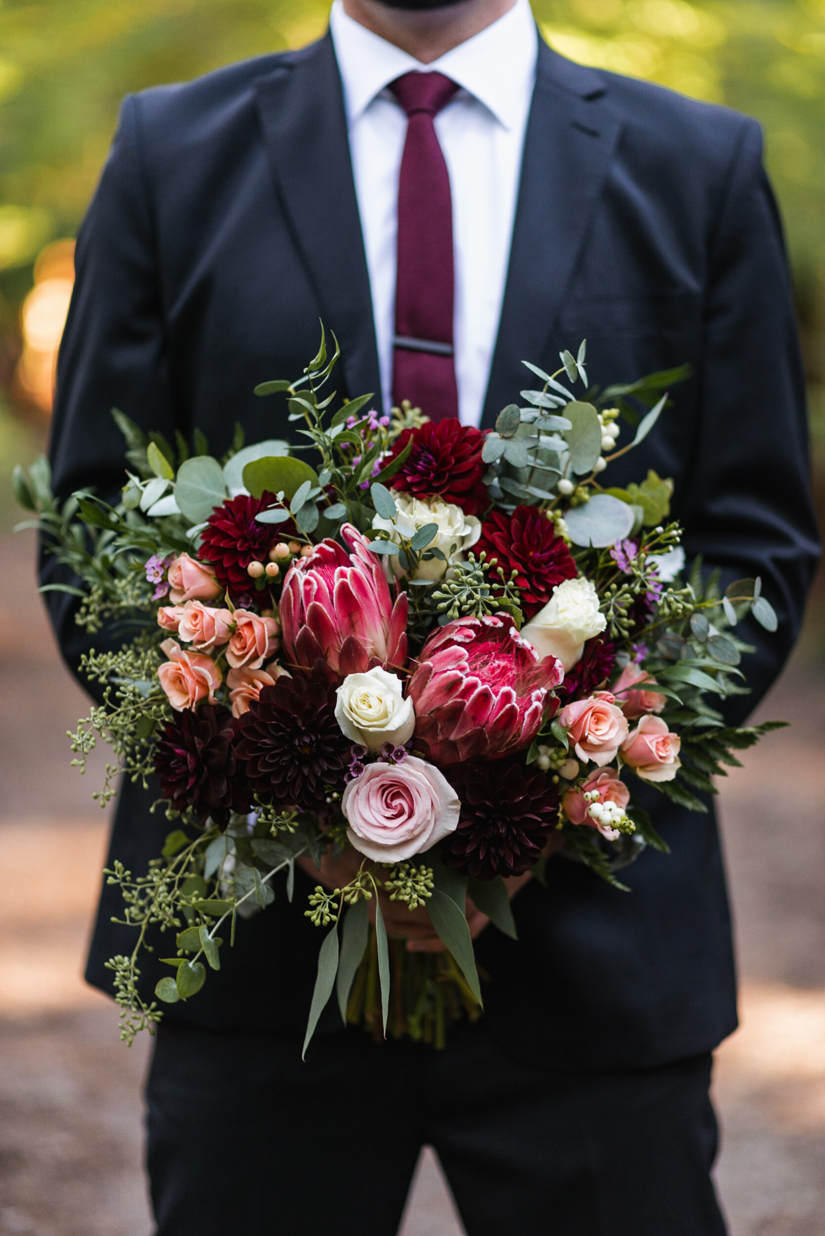 Groom holding bouquet detail