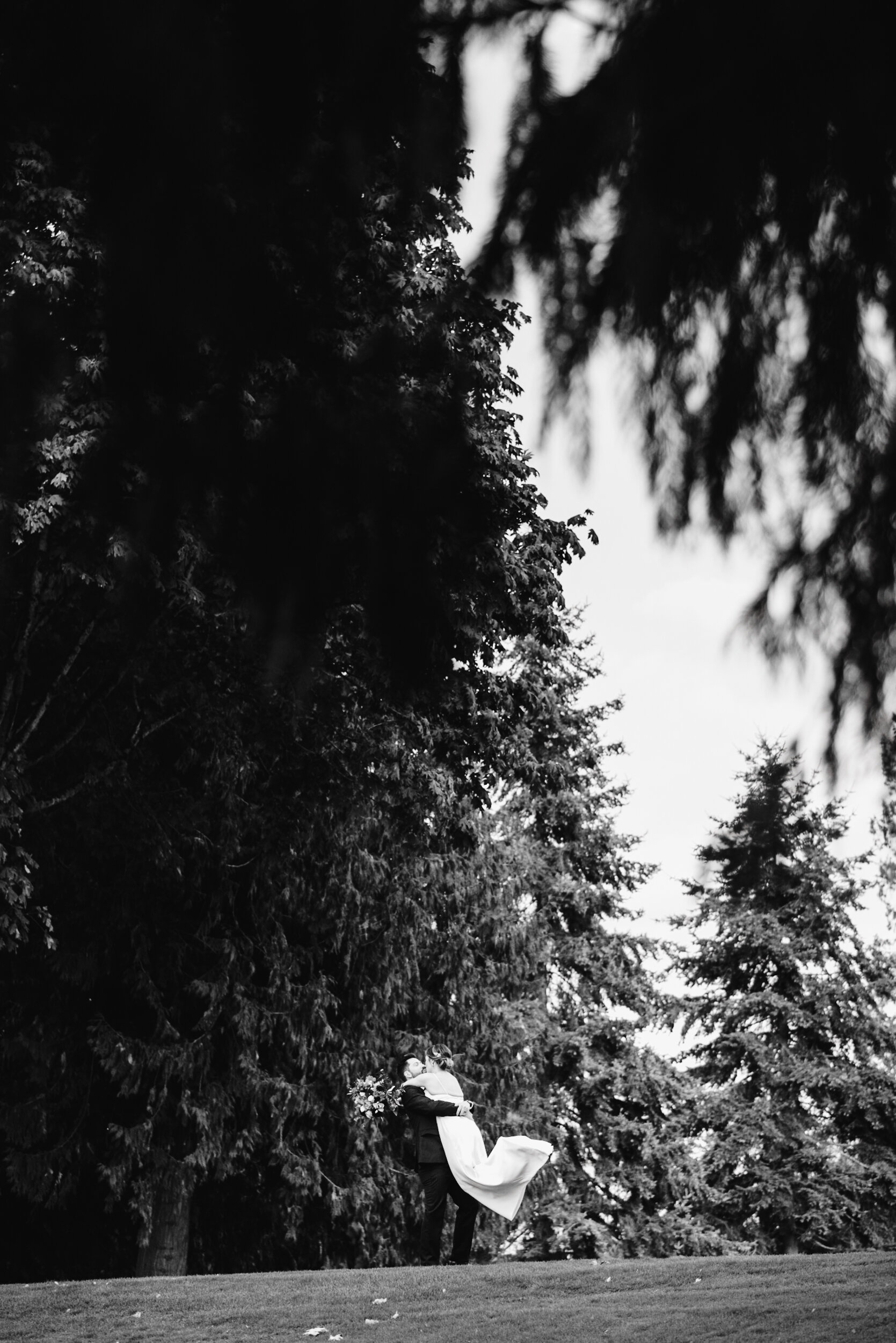 Bride and Groom standing on golf course black and white