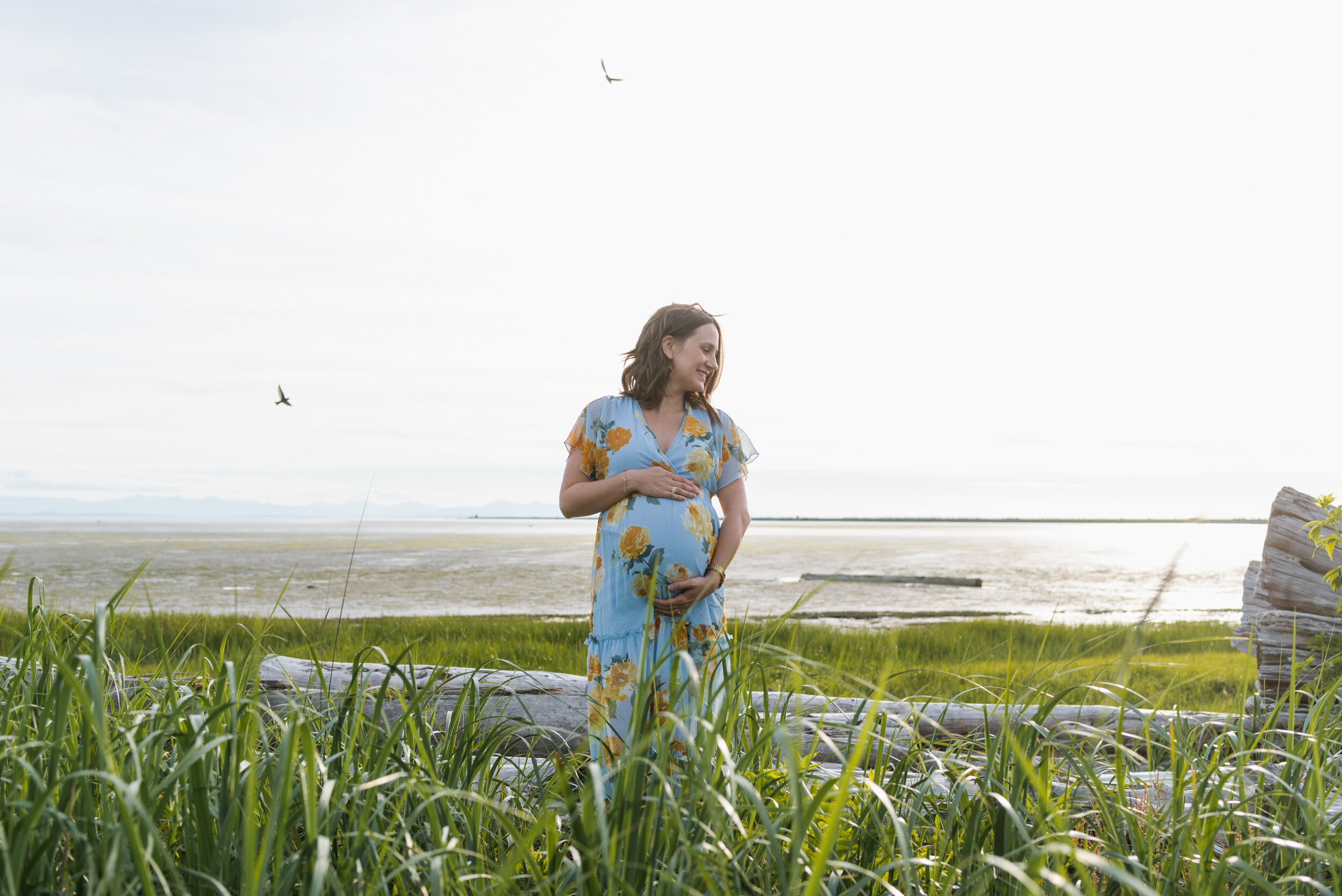 Pregnant woman beach grass birds