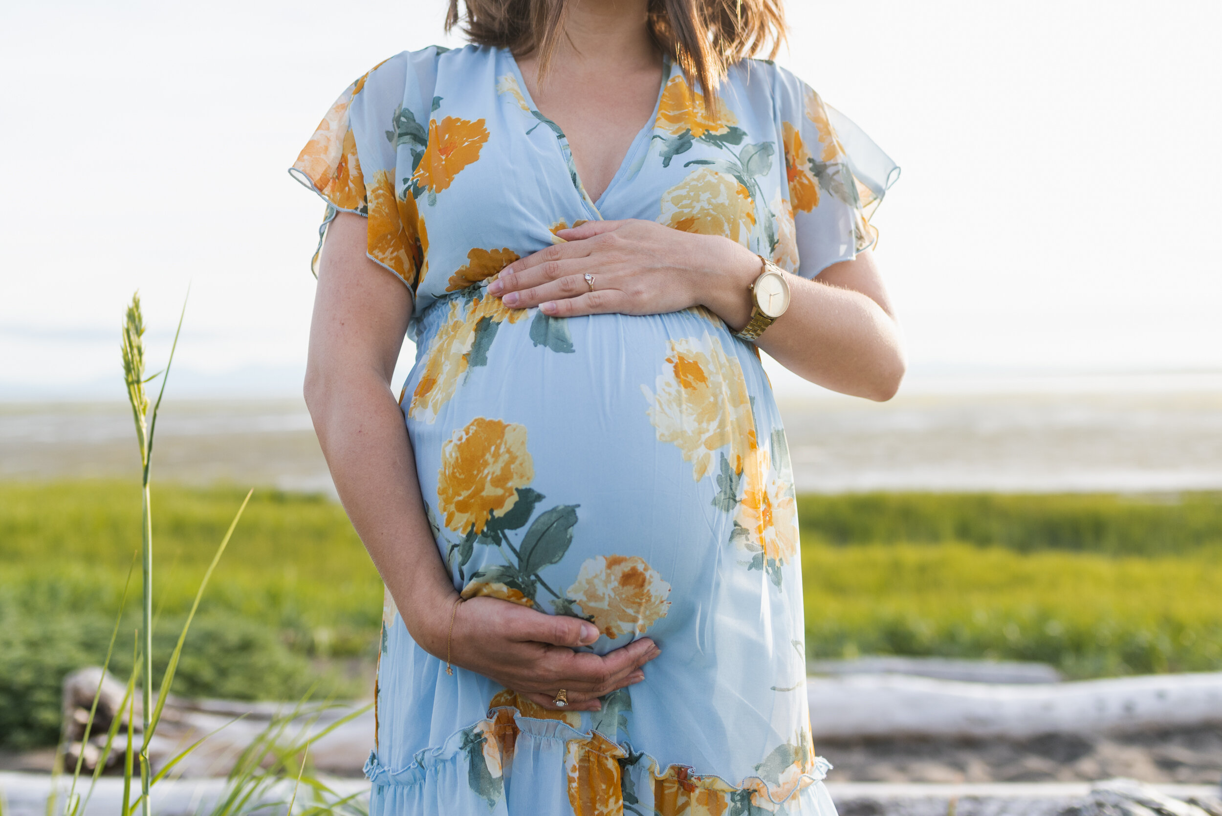 Pregnant woman beach grass belly