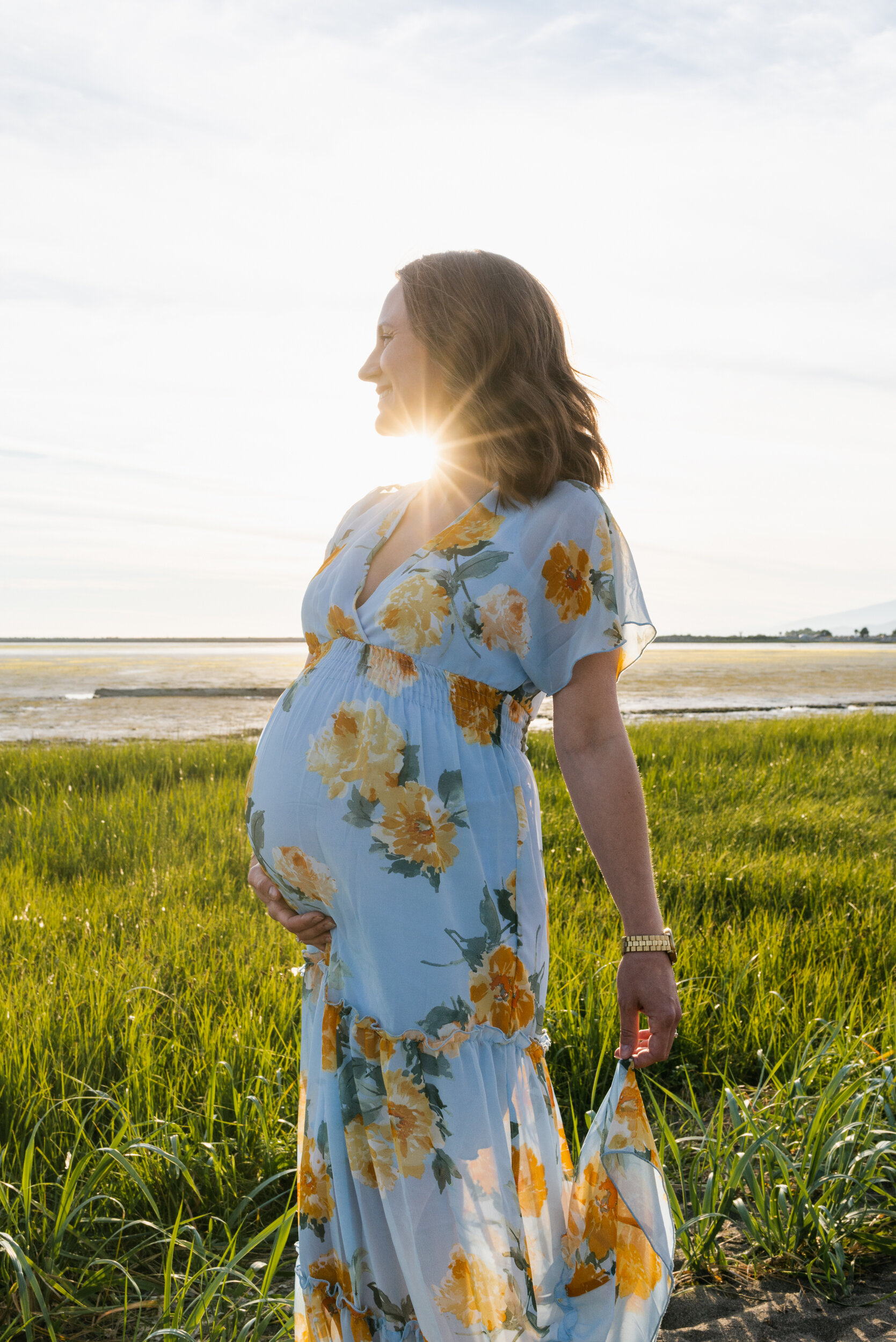 Pregnant woman beach grass sunset