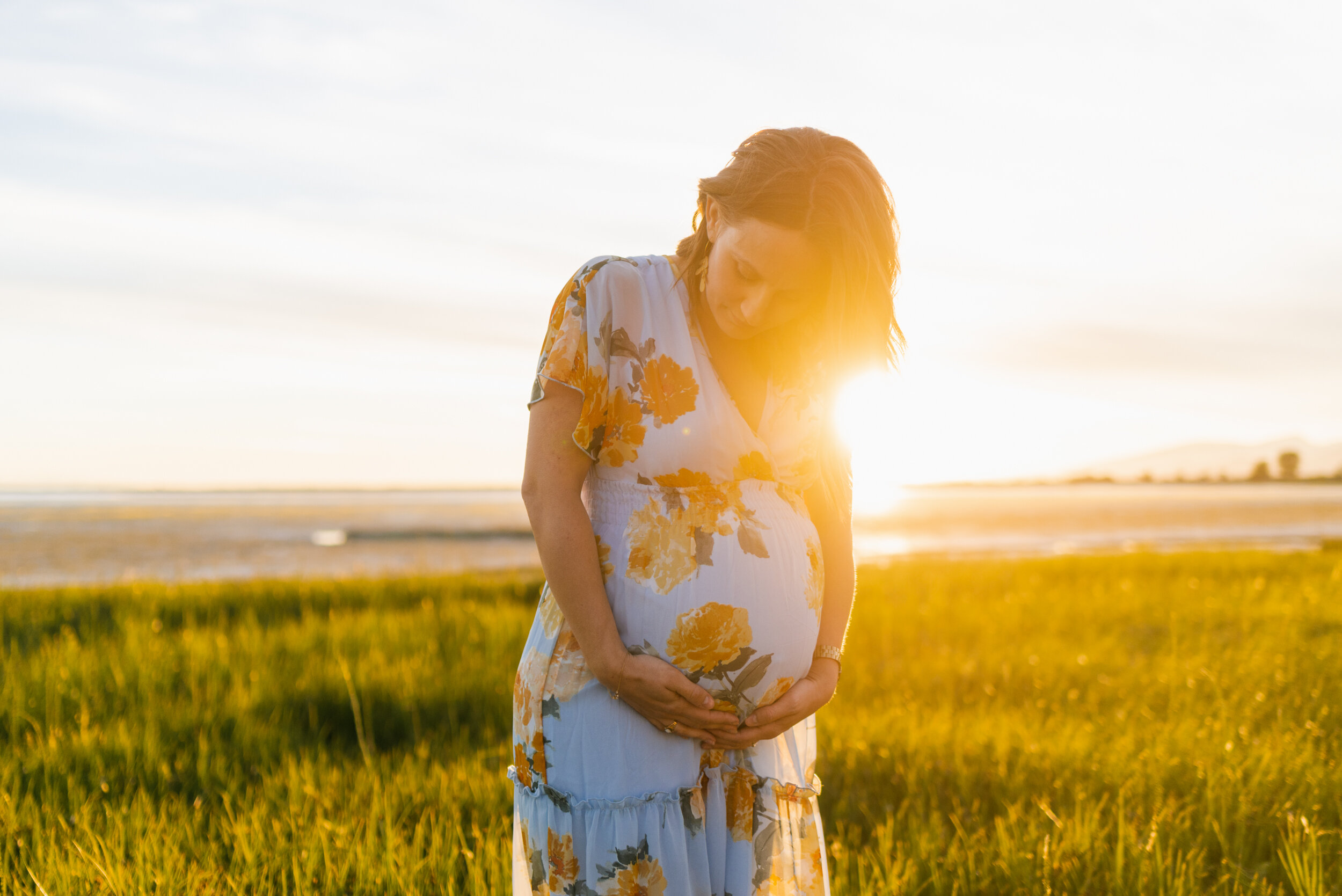 Pregnant woman beach grass sunset