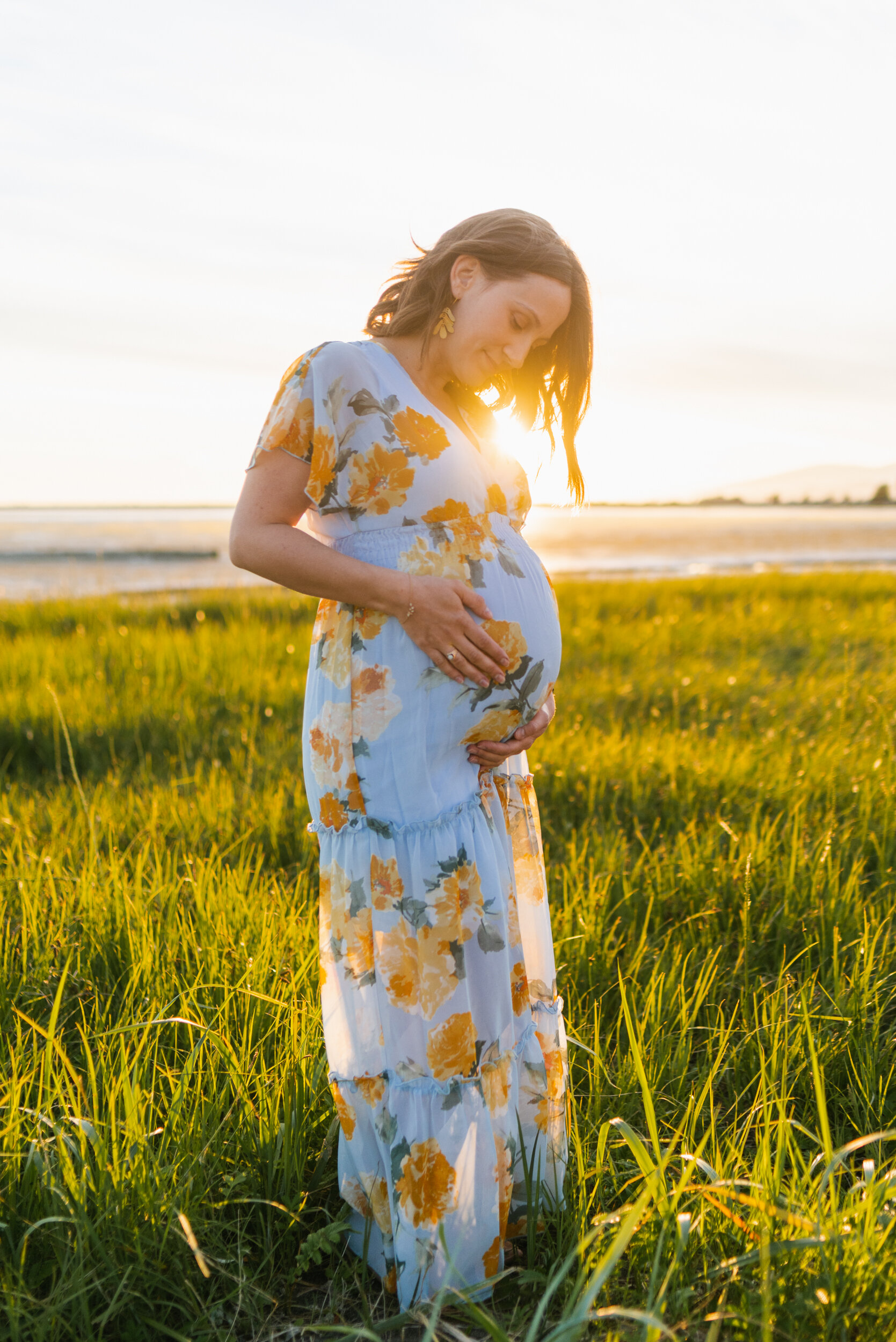 Pregnant woman beach grass sunset