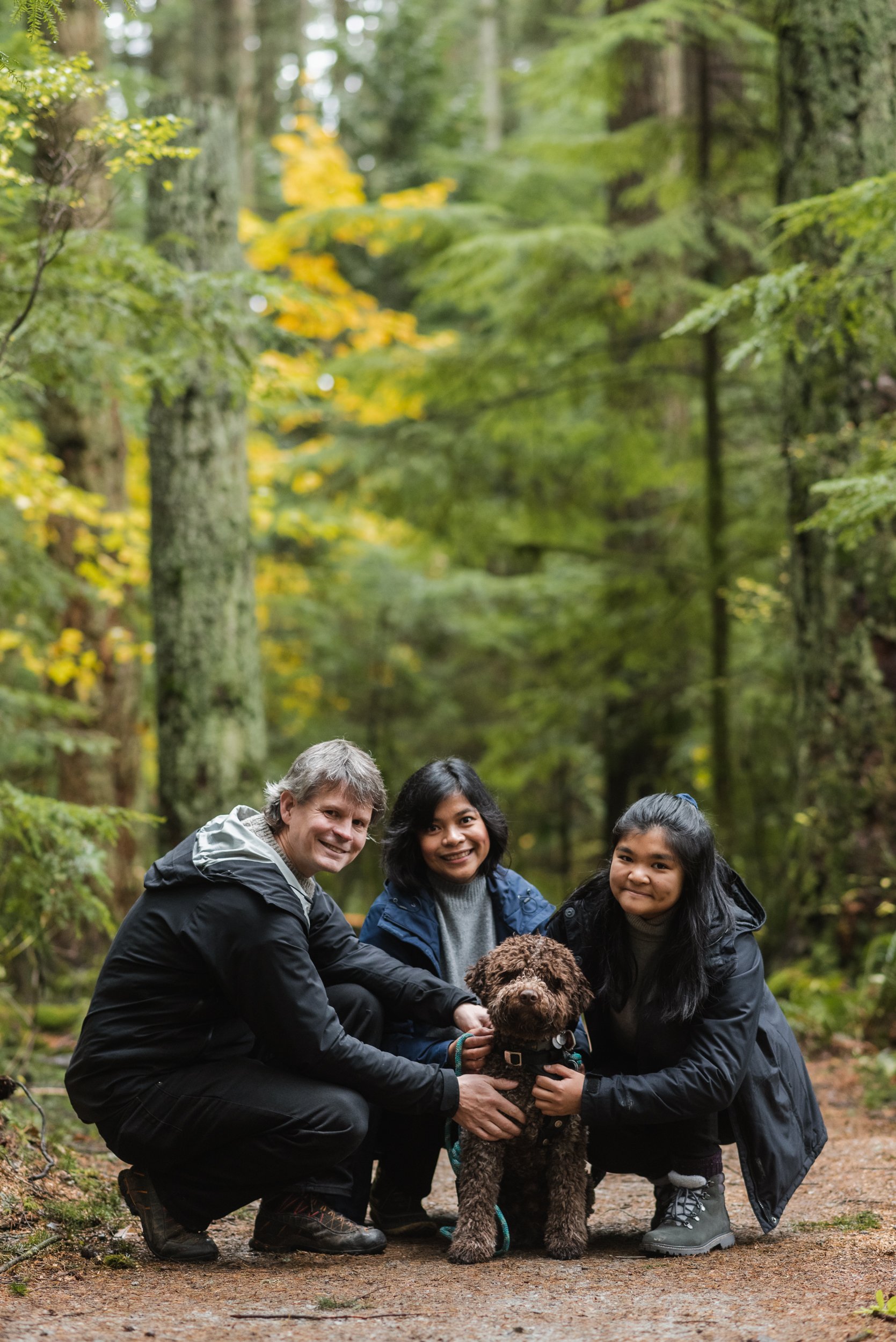 Family in forest with dog