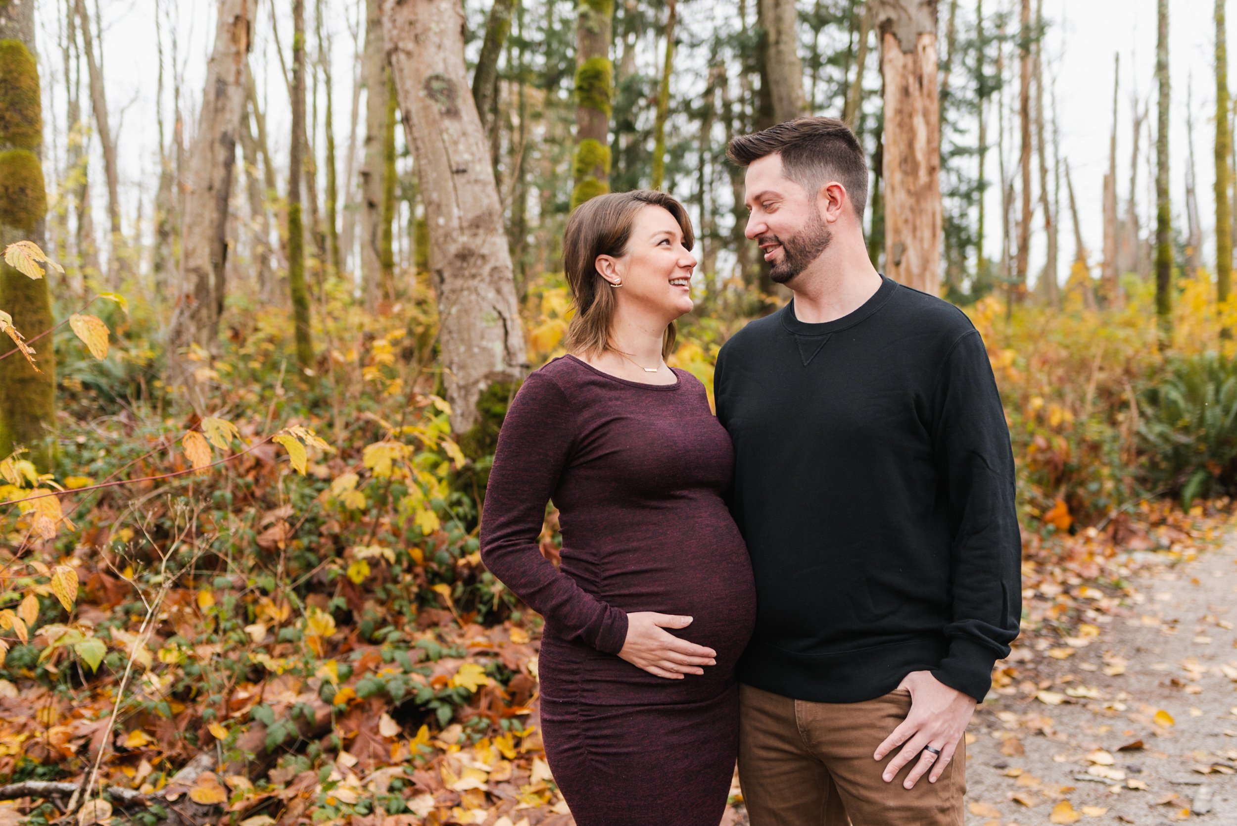 Pregnant woman with husband on forest path