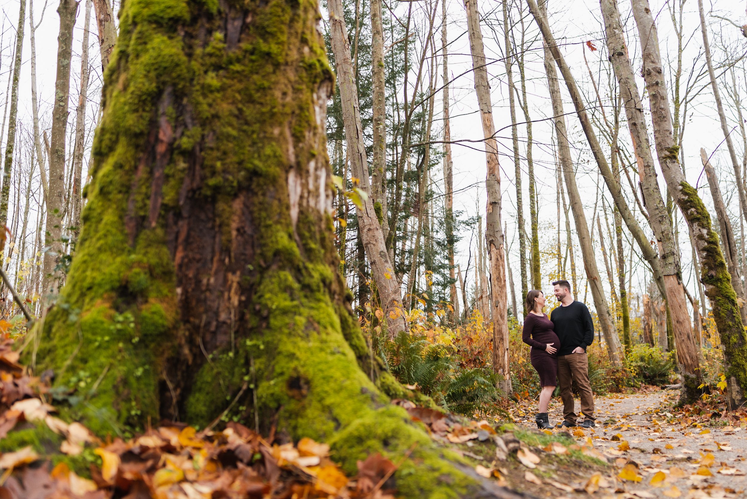 Pregnant woman with husband on forest path