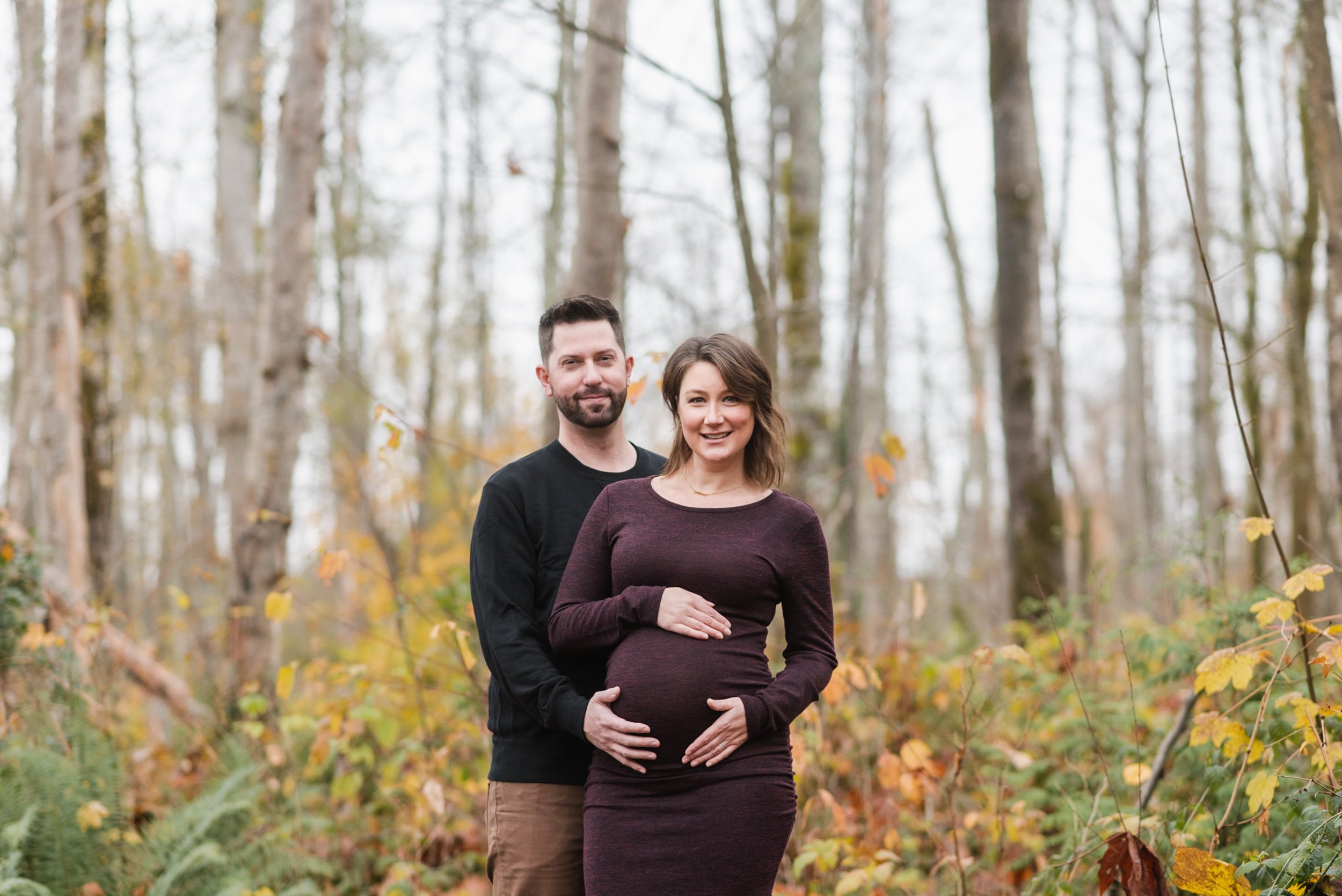 Pregnant woman with husband in forest