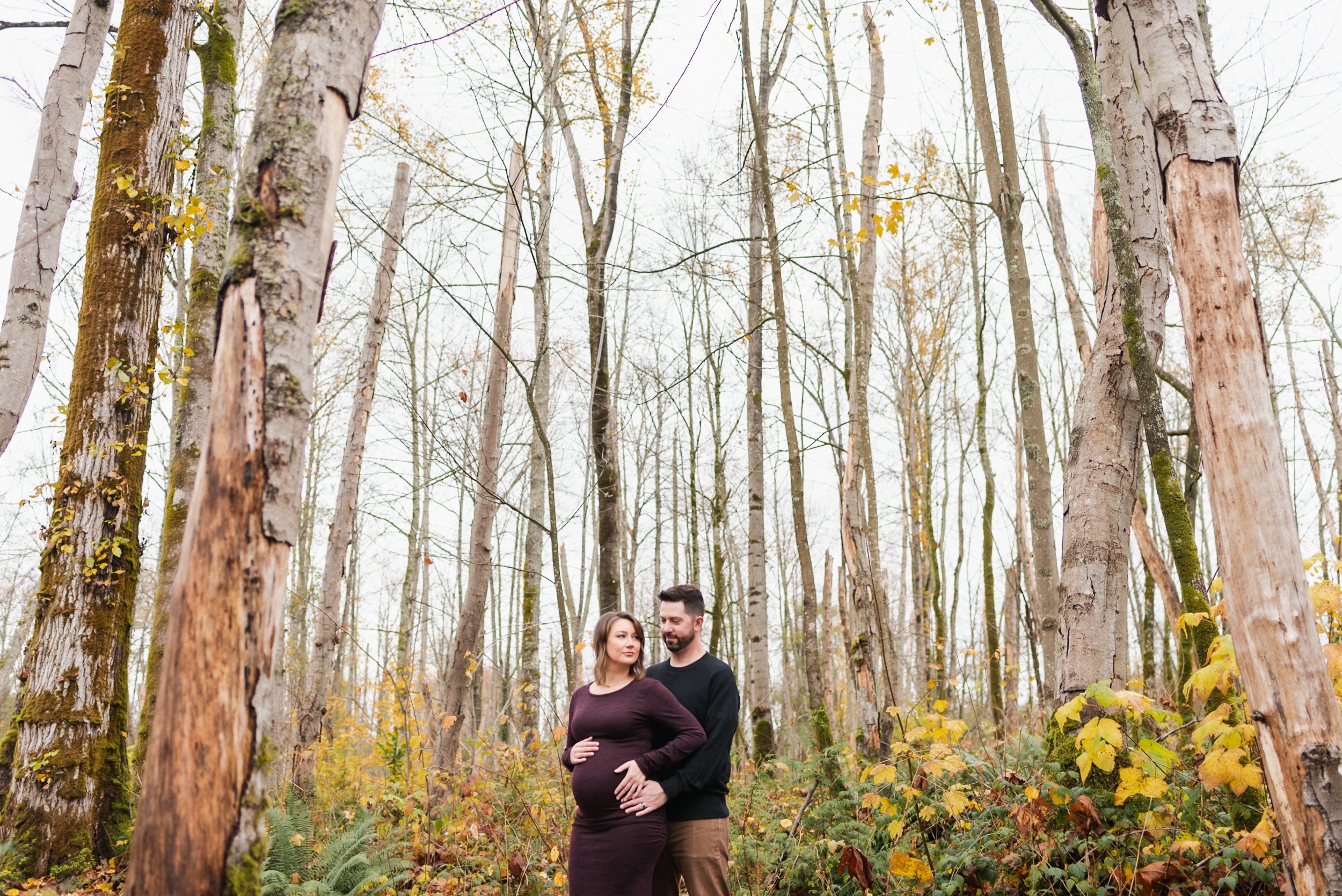 Pregnant woman with husband in forest