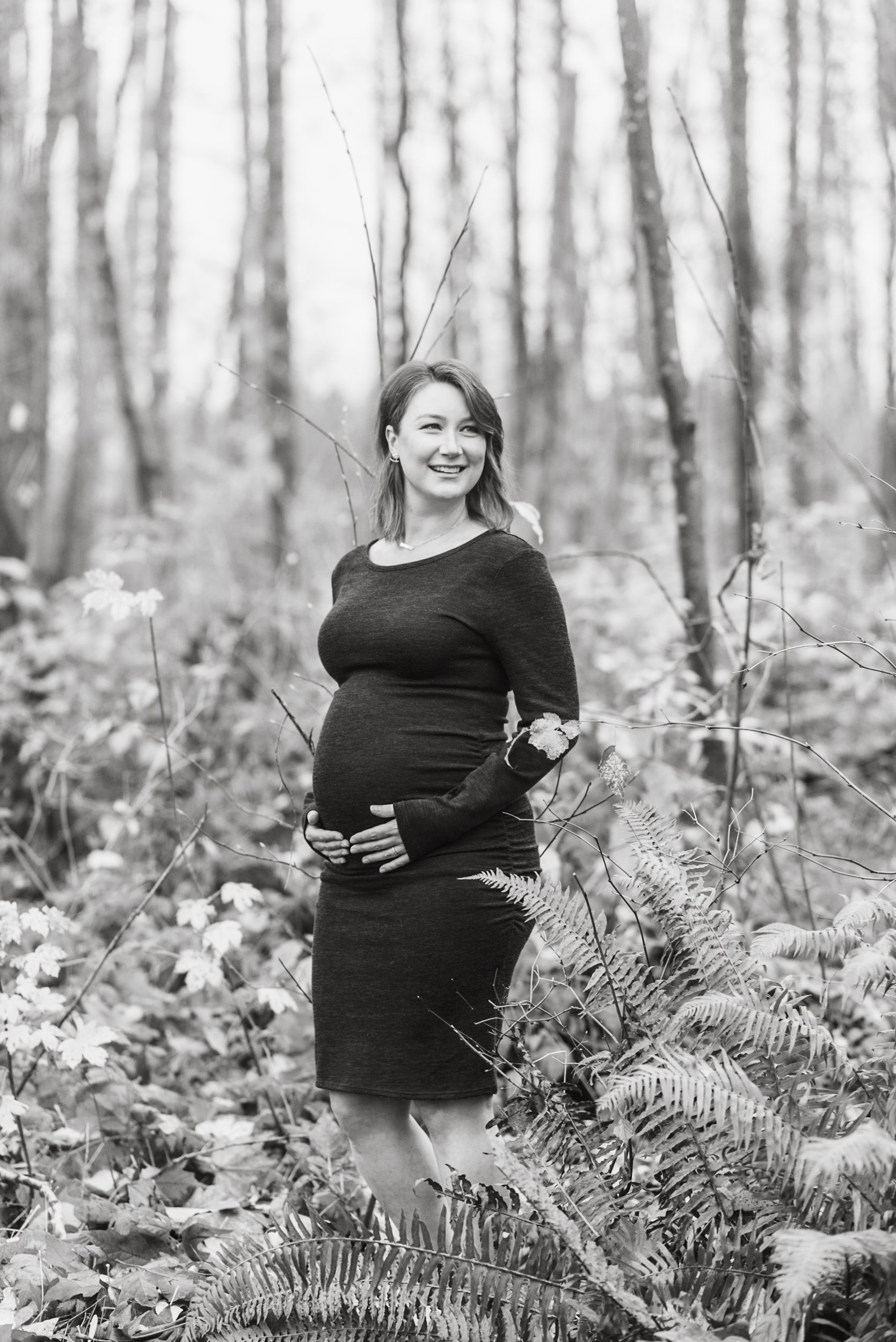 Pregnant woman in forest black and white