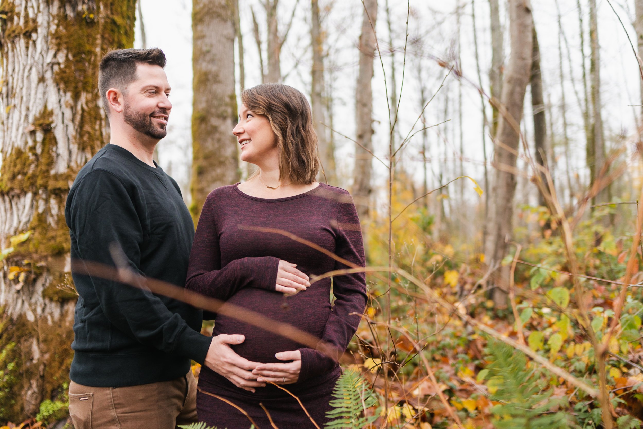 Pregnant woman with husband in forest