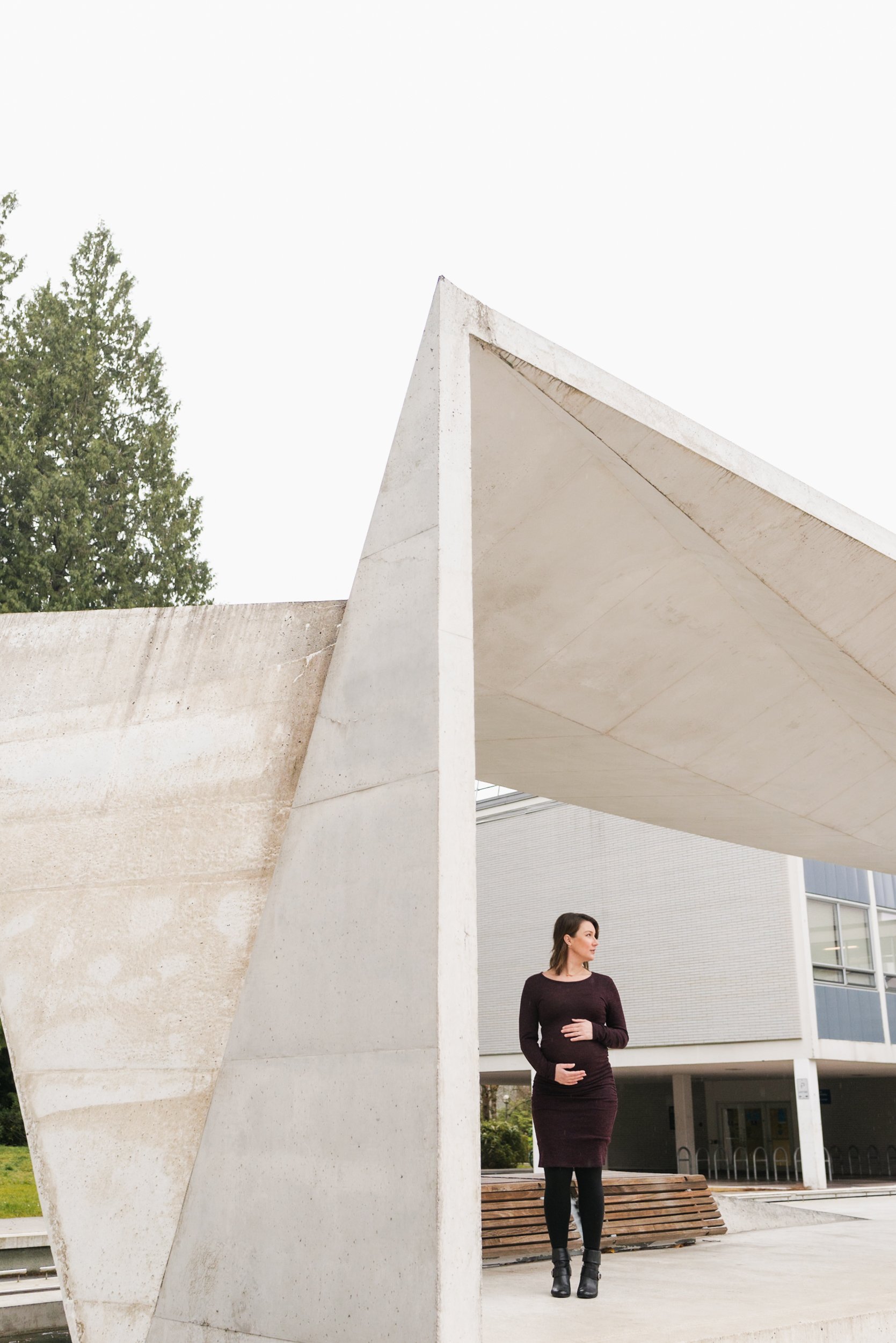 Pregnant woman standing in architectural structure