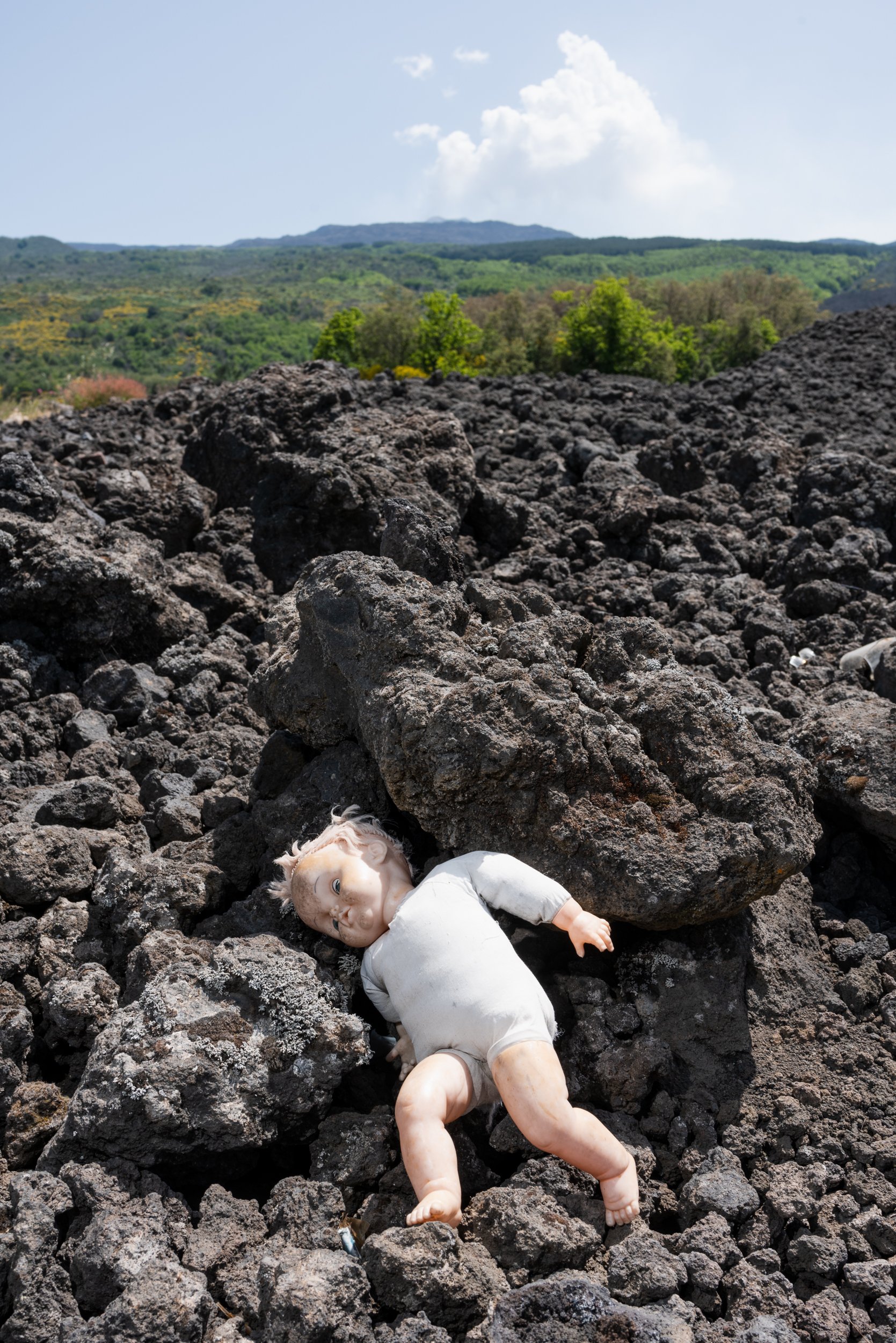 Mount Etna lava flow with doll