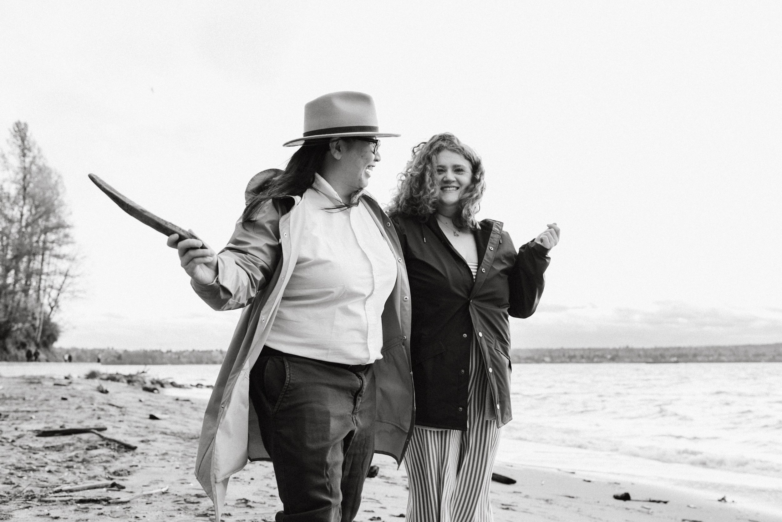 Couple with one person about to throw stick at Stanley Park's Second Beach