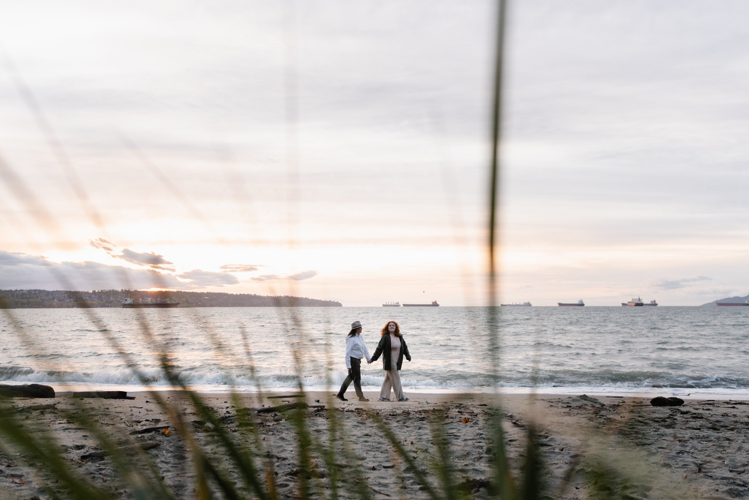 Wide shot of couple walking at Stanley Park's Second Beach