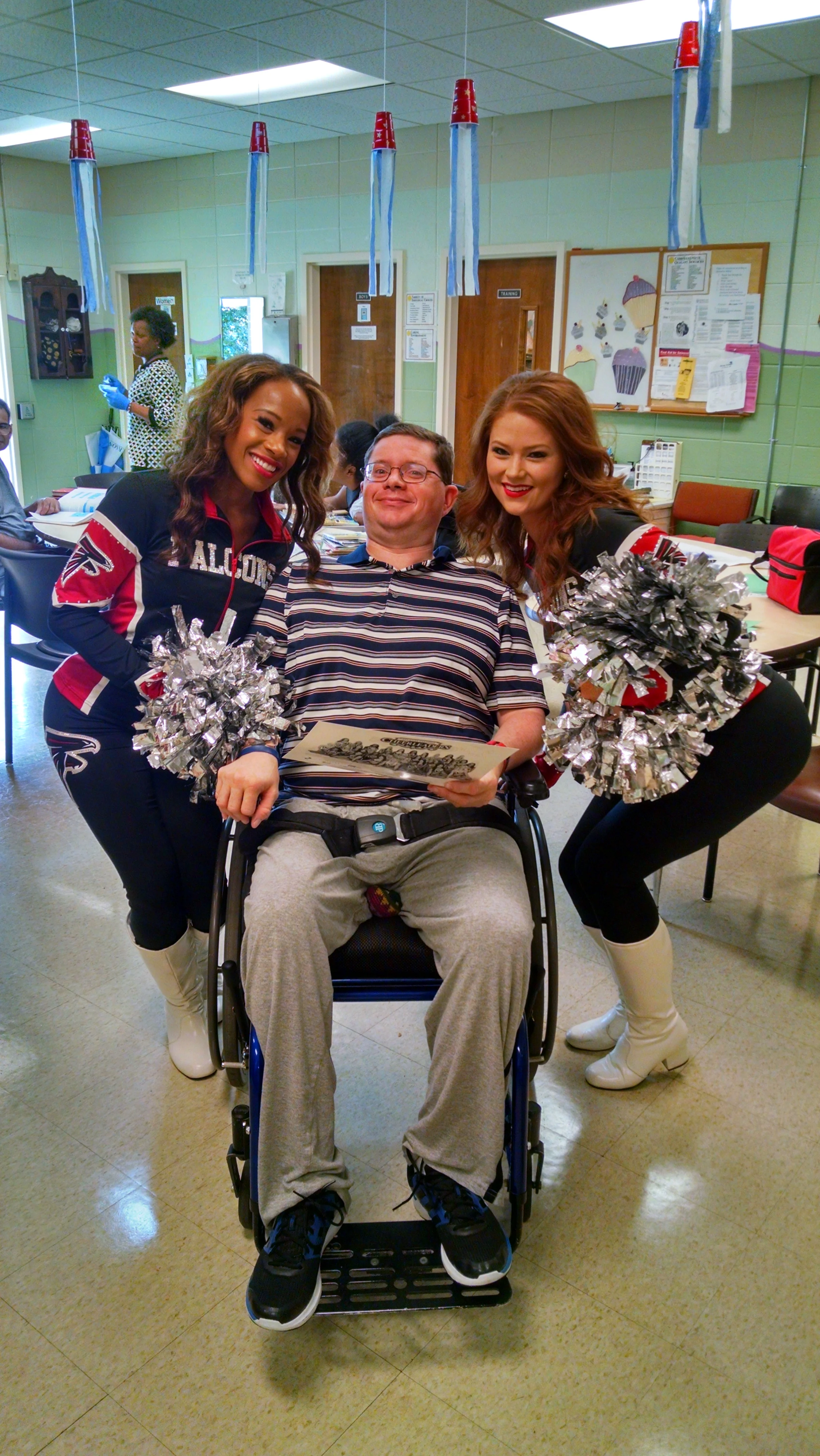 A happy Dan surrounded by Cheerleaders.jpg