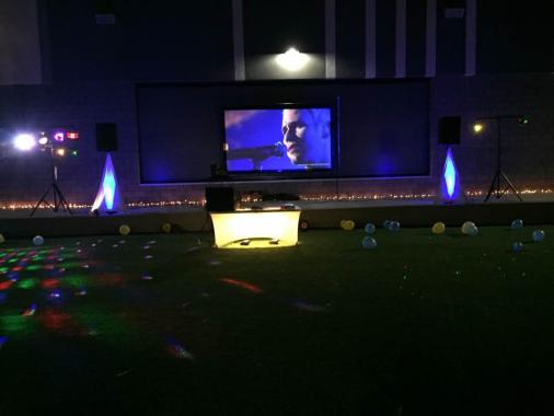 setup for a middle school dance with 12' video screen and projector