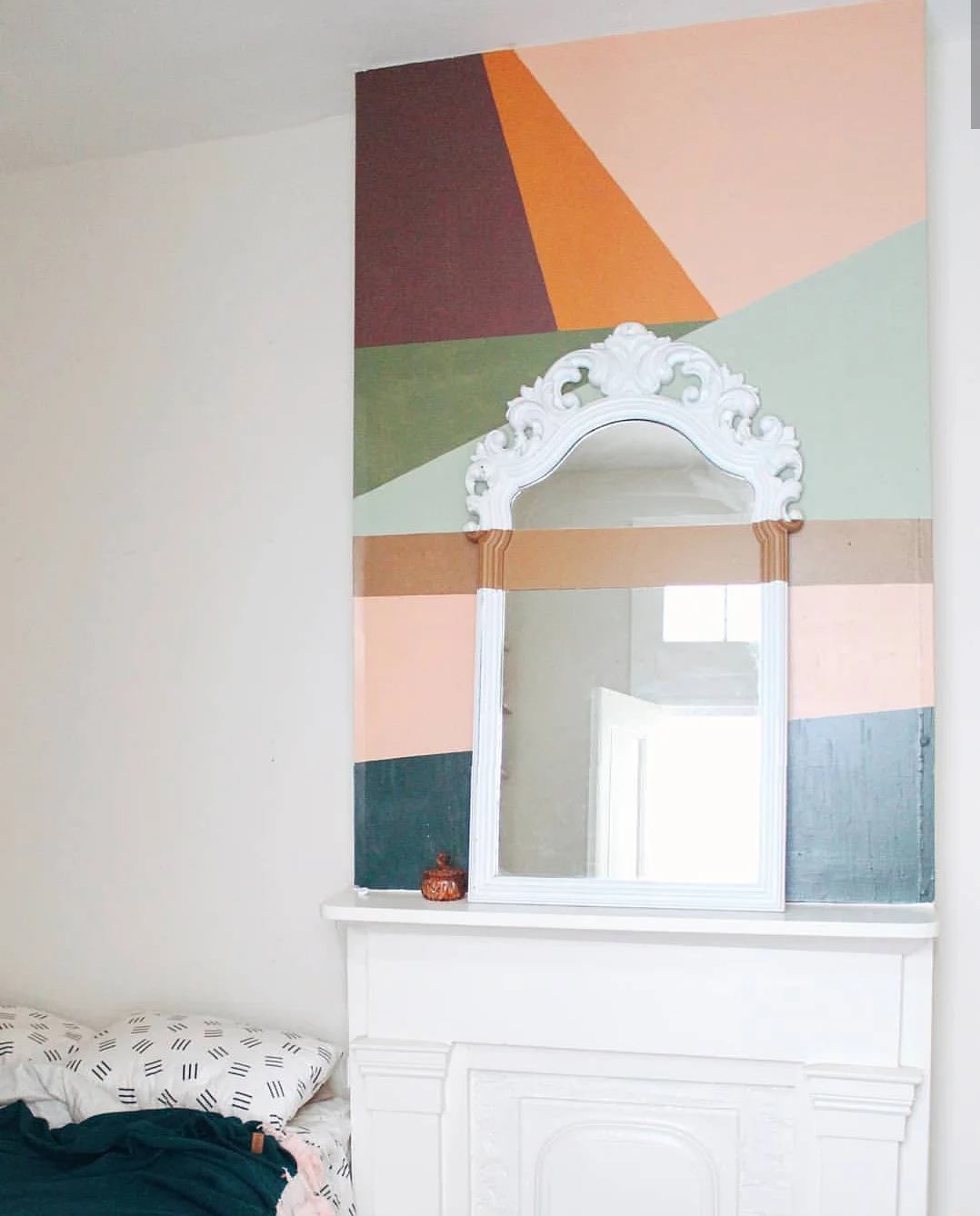 Simple color blocking with a strip of paint across the mirror. Little details that can make a space unique.