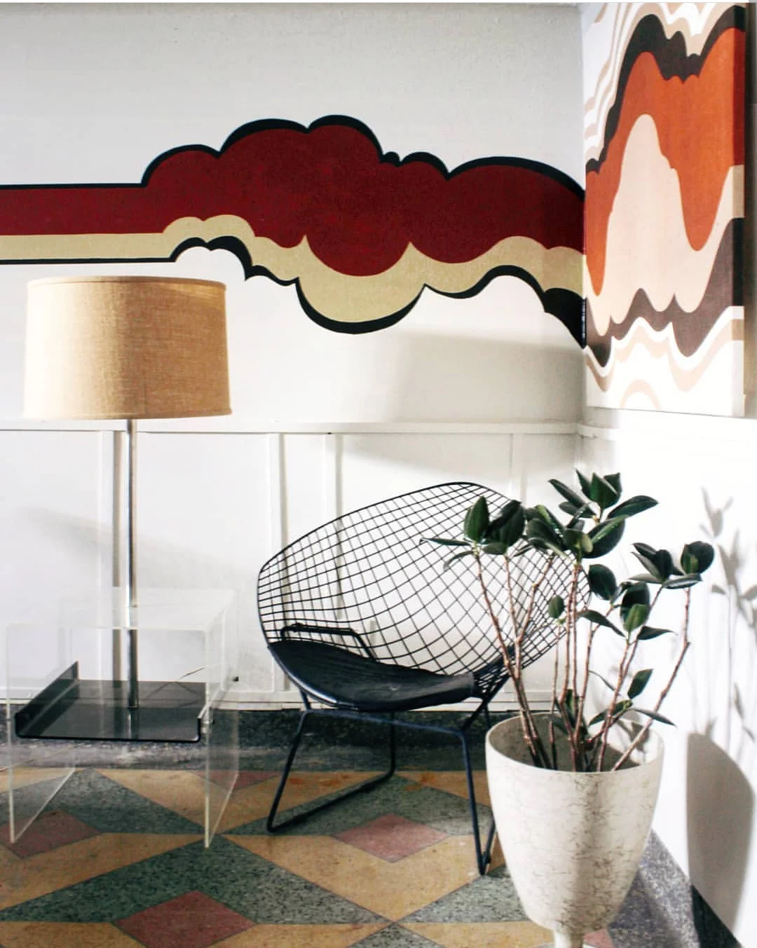 This wall painting was inspired by the art hanging to the right and extended on to the wall.