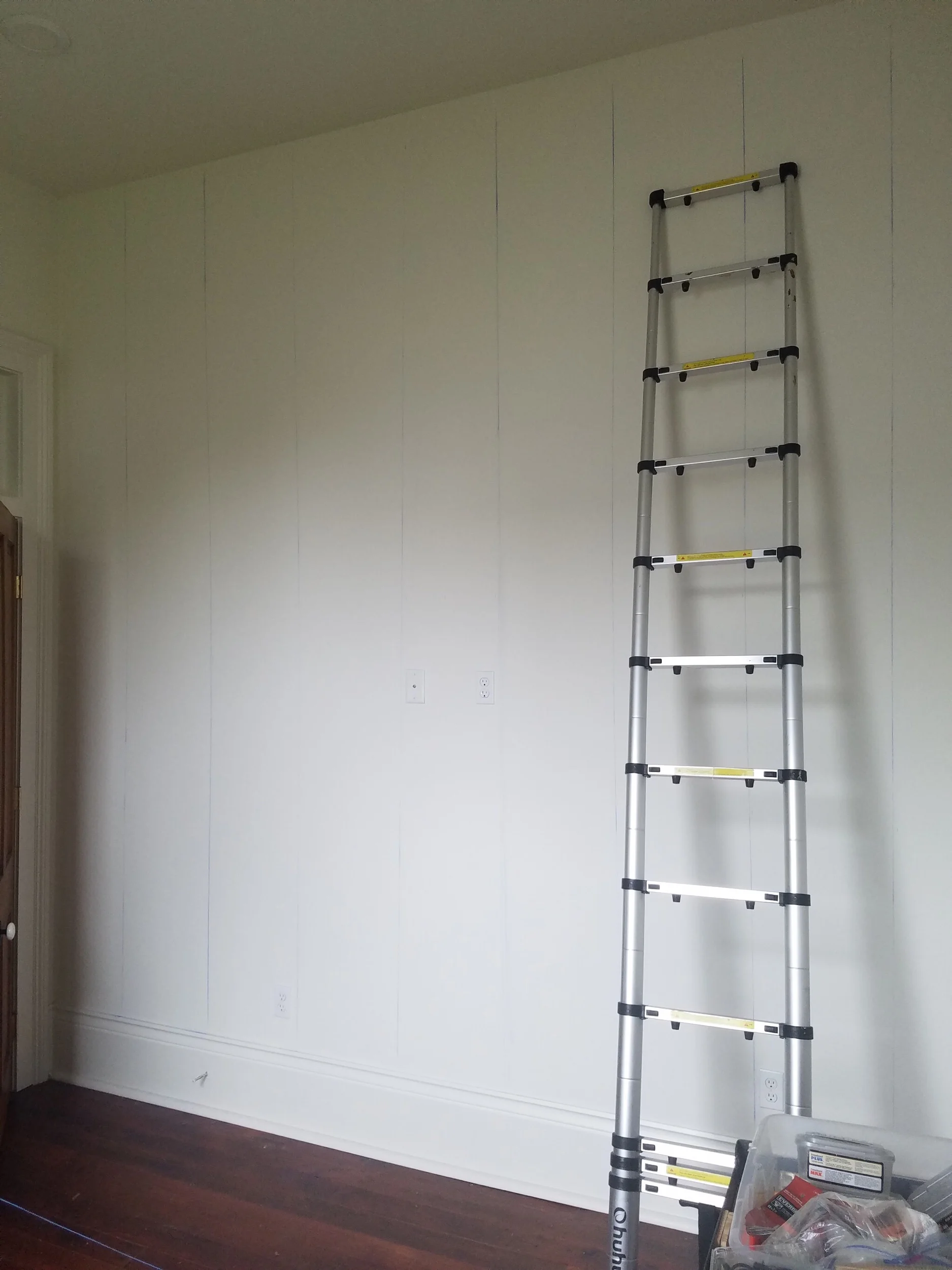 We used a stud finder and chalk string to mark the stud lines on the wall. Each panel needed to hit at least one stud to be secure.