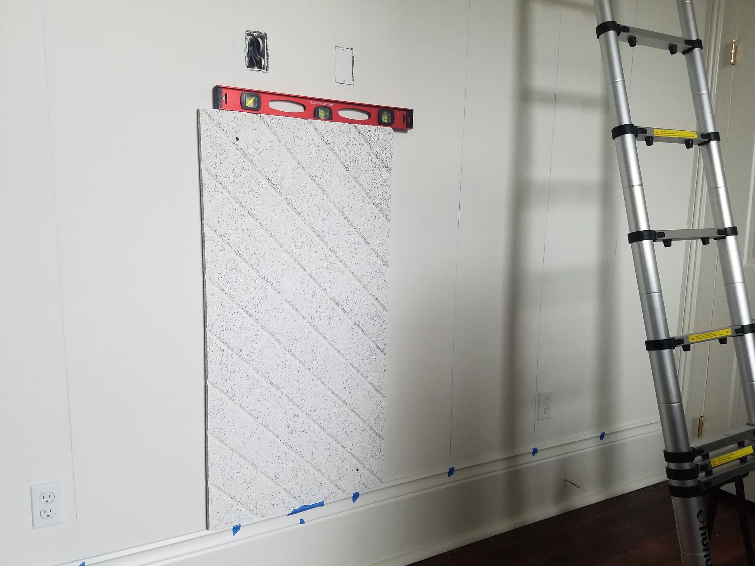 We started with the first panel in the middle of the room and worked our way out from there making sure that it was perfectly level.