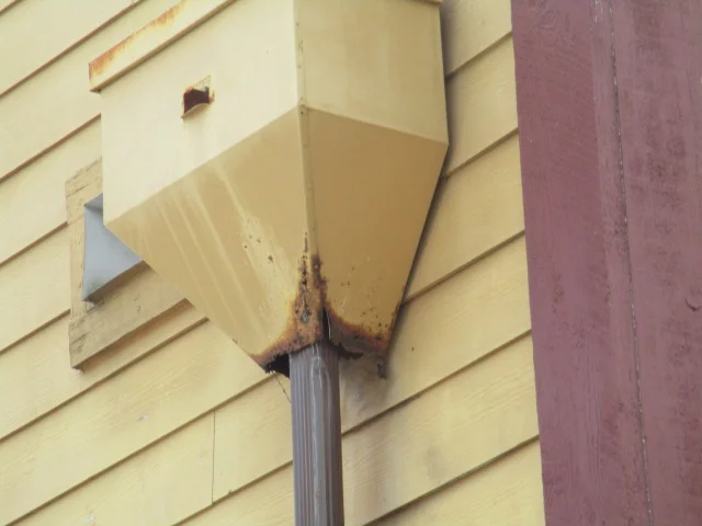 Gutter downspout rusted through, replaced with PVC Pipe