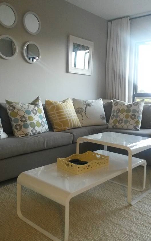 Closing up an unused door to lengthen the wall and adding New art work, carpet, paintwork and coffee table with new colour adds vibrancy & practicality to this lounge.