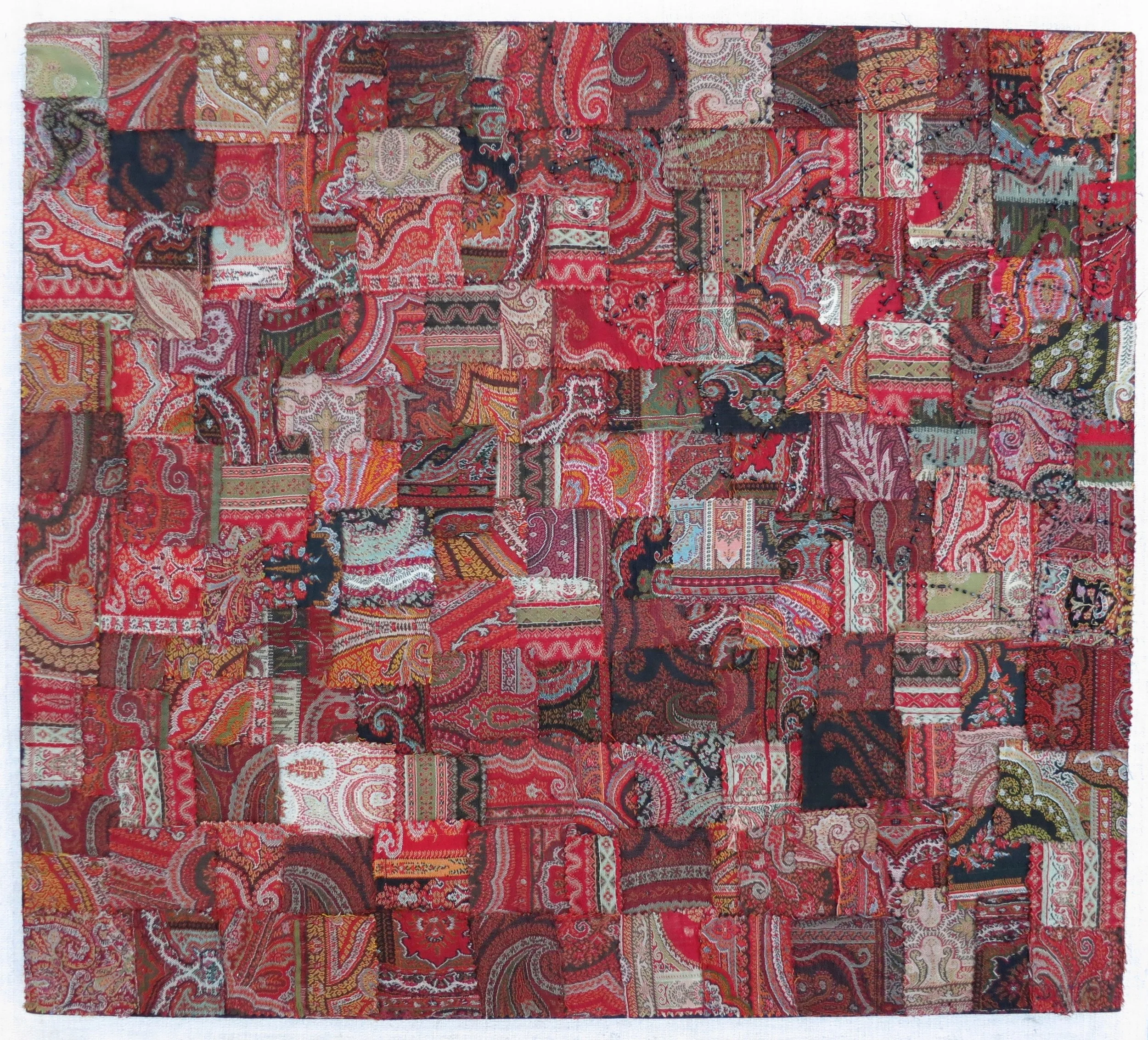 Paisley Pieces 2014 20" x 20" Antique paisley remnants and glass beads (spider web design in upper right corner) hand sewn on cotton. Stretcher mounted.