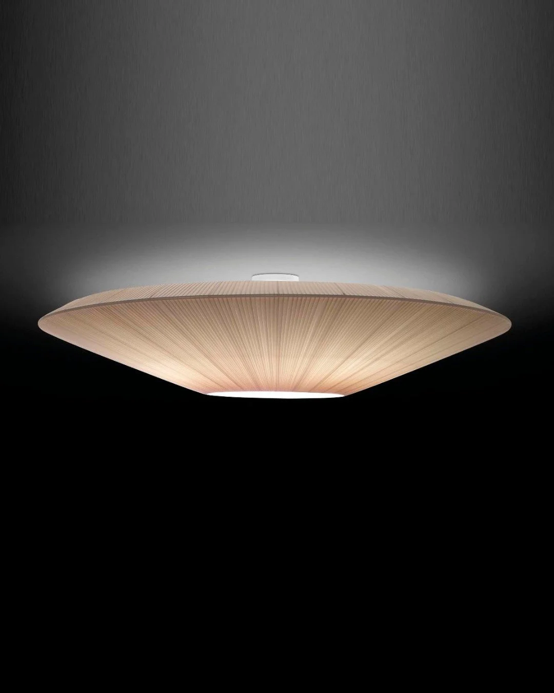 Chicago Lightworks presents the Siam 150 by Bover, a large-scale ceiling fixture designed to shape space through light.

Its ribbon-like shade wraps the light source, diffusing it into a soft, even glow that spreads both downward and outward. The res