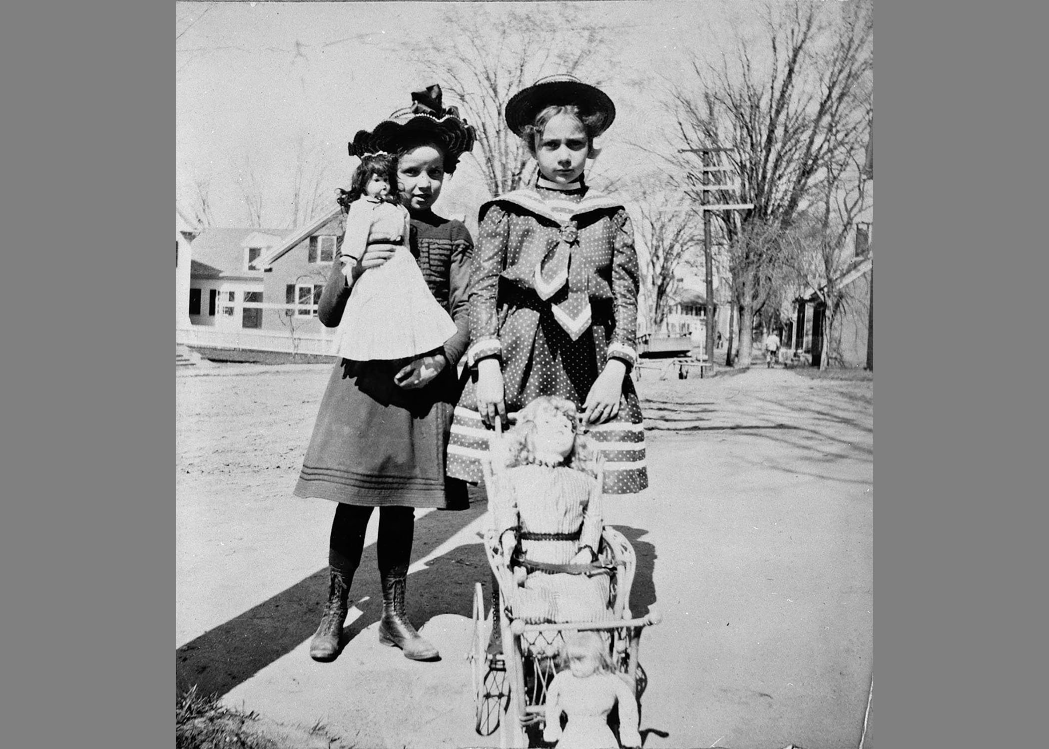 Girls on Central Street with their dolls