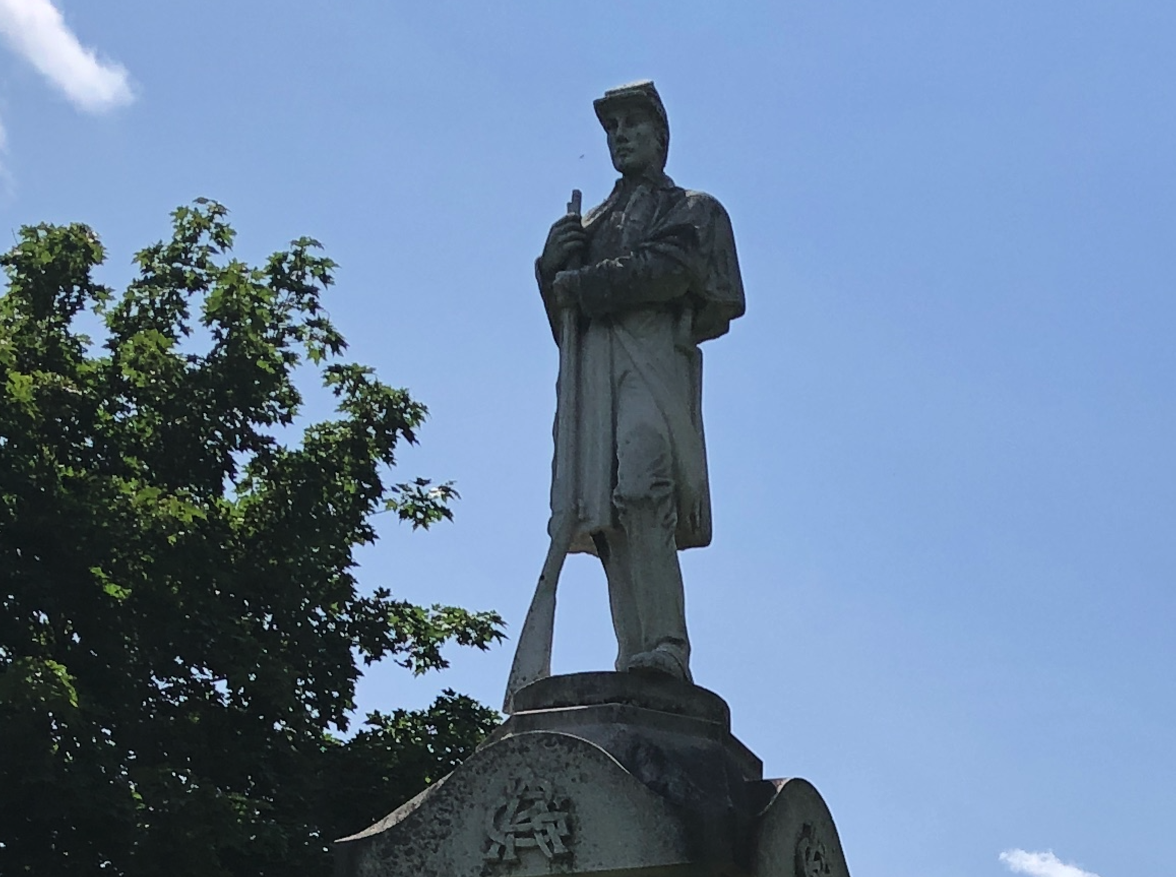 The monument features a soldier. The base is inscribed “In Memory/of the Boys of/Woodstock and/Vicinity who/Served in the Army/and Navy of the/Nation in the War/of the Rebellion/of ’60 to ’65.”