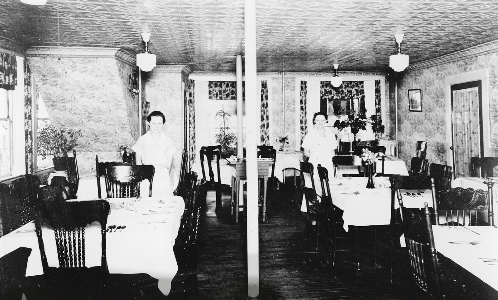 If we step inside, we can get a view of the dining room as it appeared in the 1930s. Just look at the gorgeous tin ceiling!